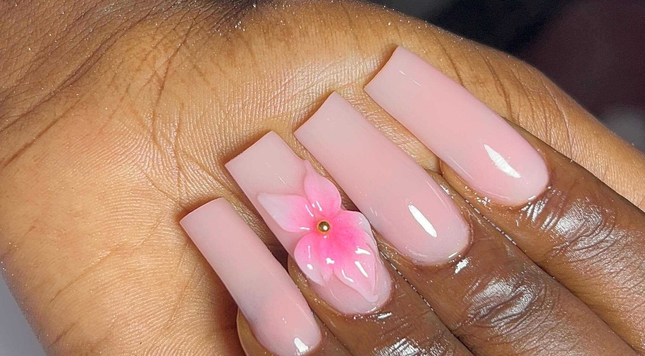 Elegant pink nails with floral design at DEAREST BEAUTY STUDIO, Lagos, Lagos, NG.