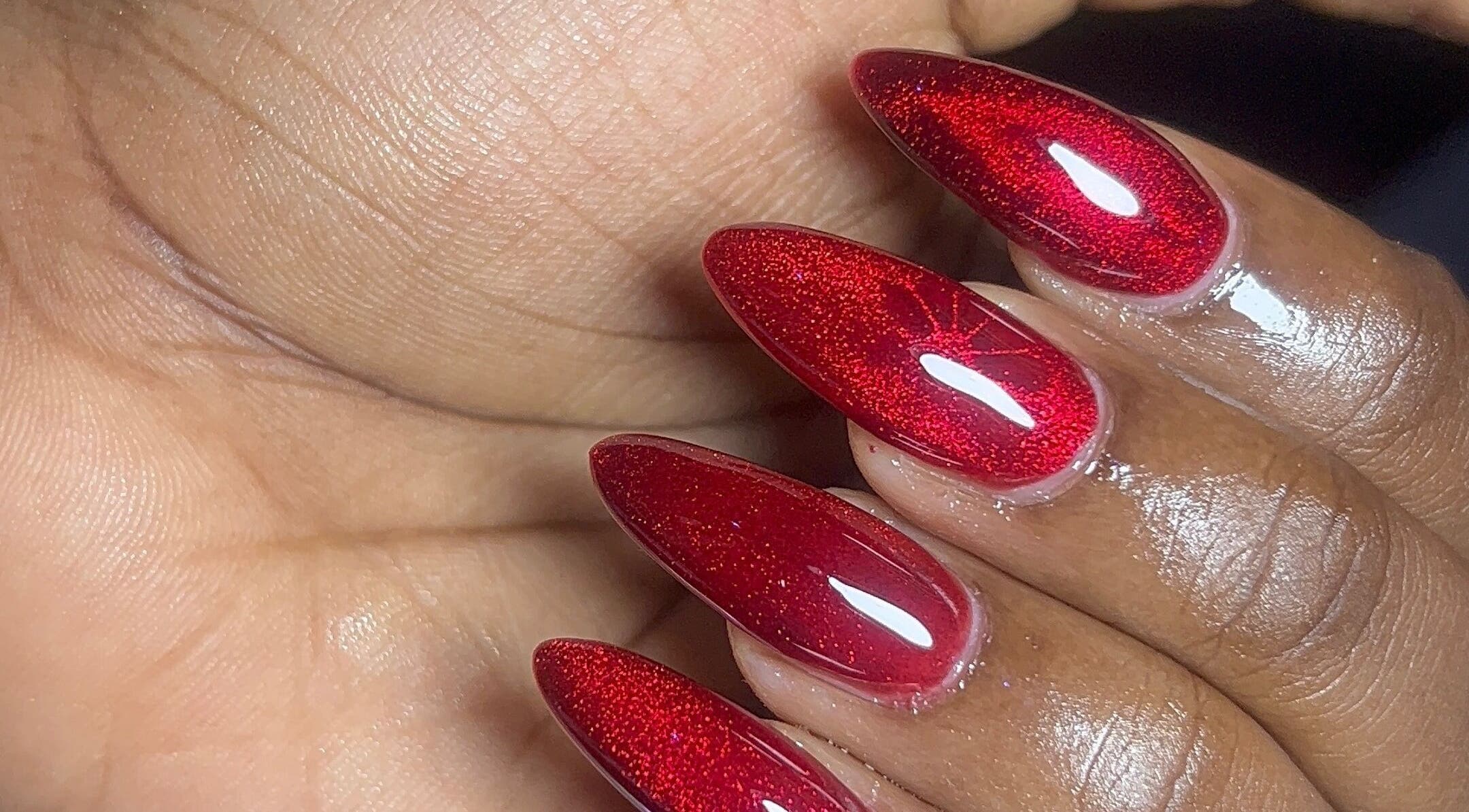 Glossy red nails at DEAREST BEAUTY STUDIO, Lagos, NG, showcasing exquisite nail art detail.