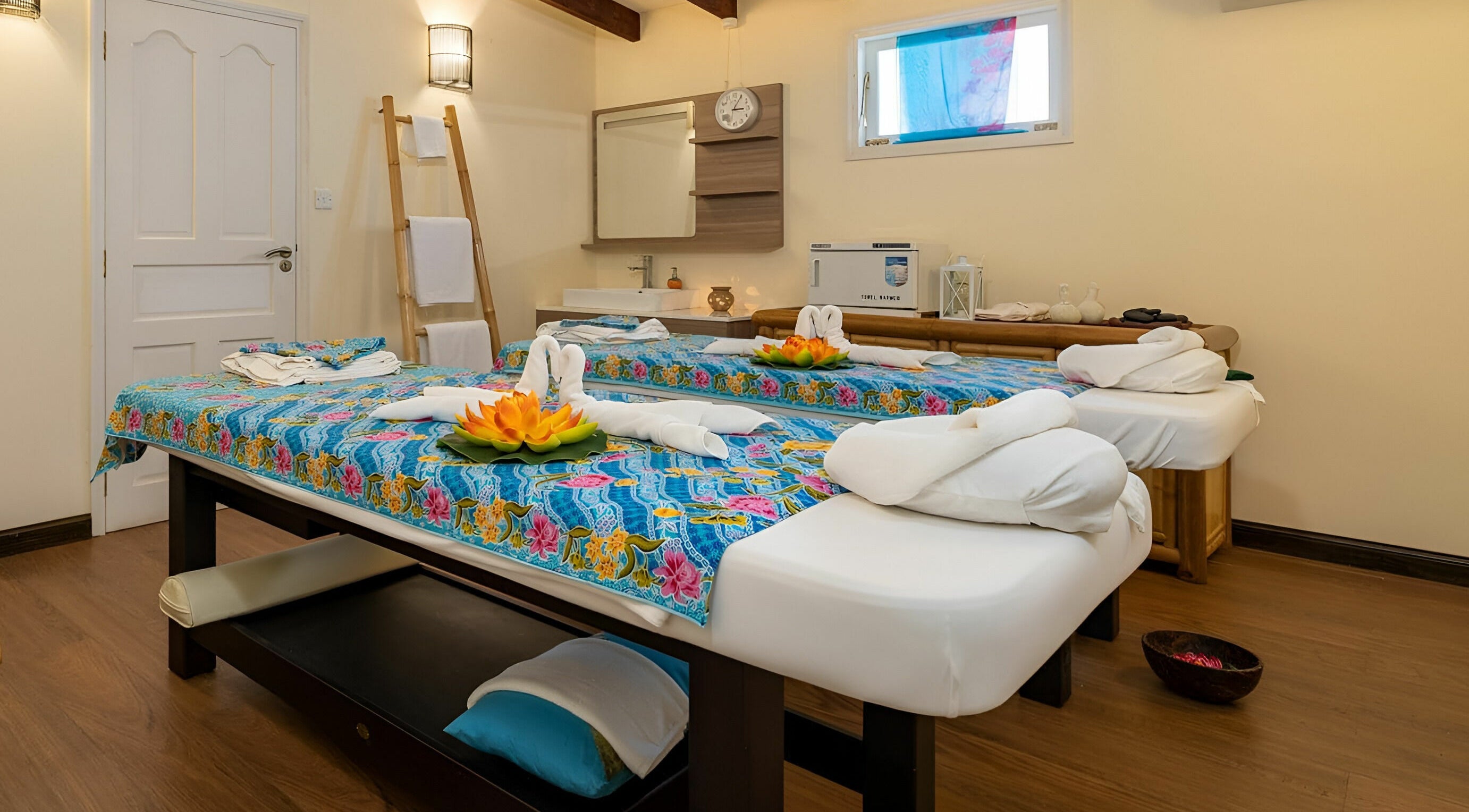 Massage tables at Peppermint Spa Angel Fish Bayside Marina in Victoria, SC are elegantly arranged with floral decor.