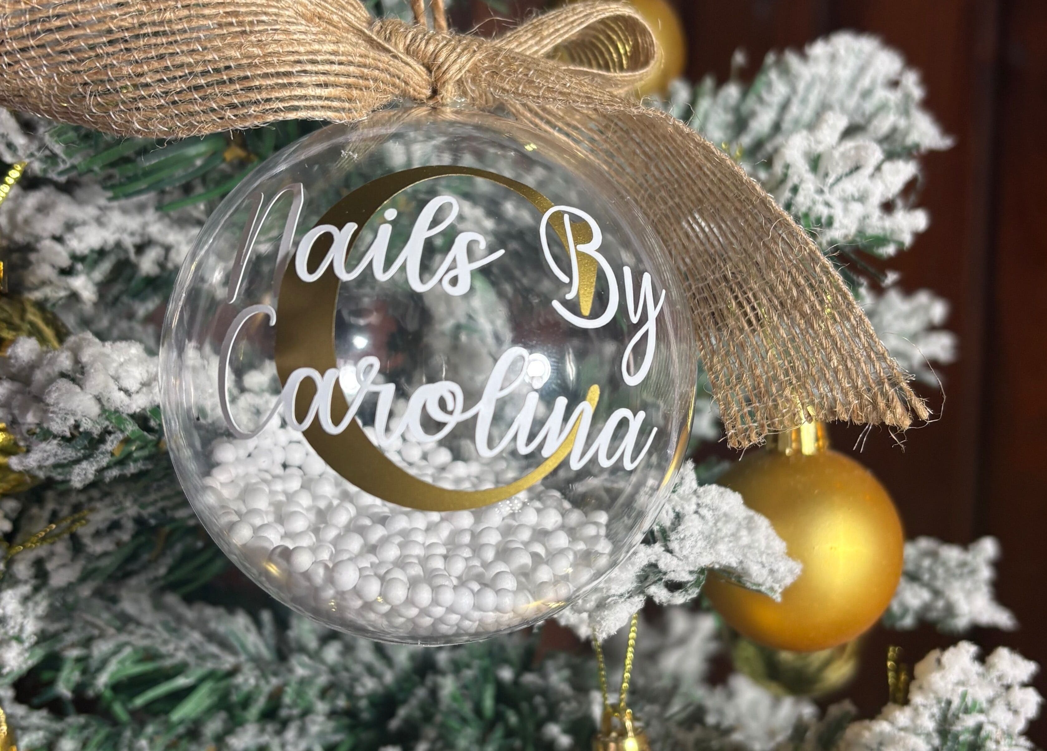 Elegant Christmas ornament at Nails By Carolina, PT decorated with snow-frosted accents.