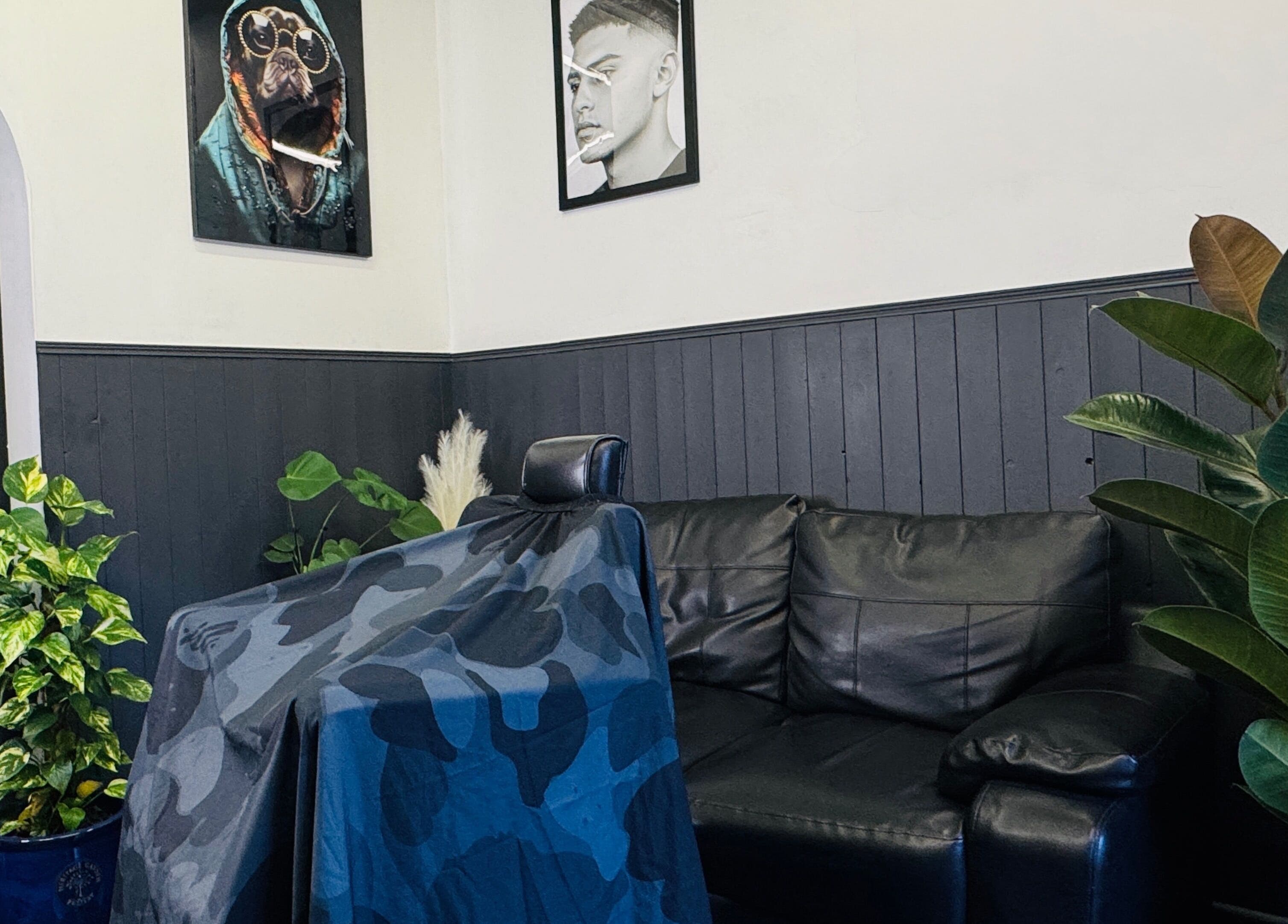 Chic interior of GavBarber in Darwen, England, GB featuring leather seating, vibrant plants, and modern decor.