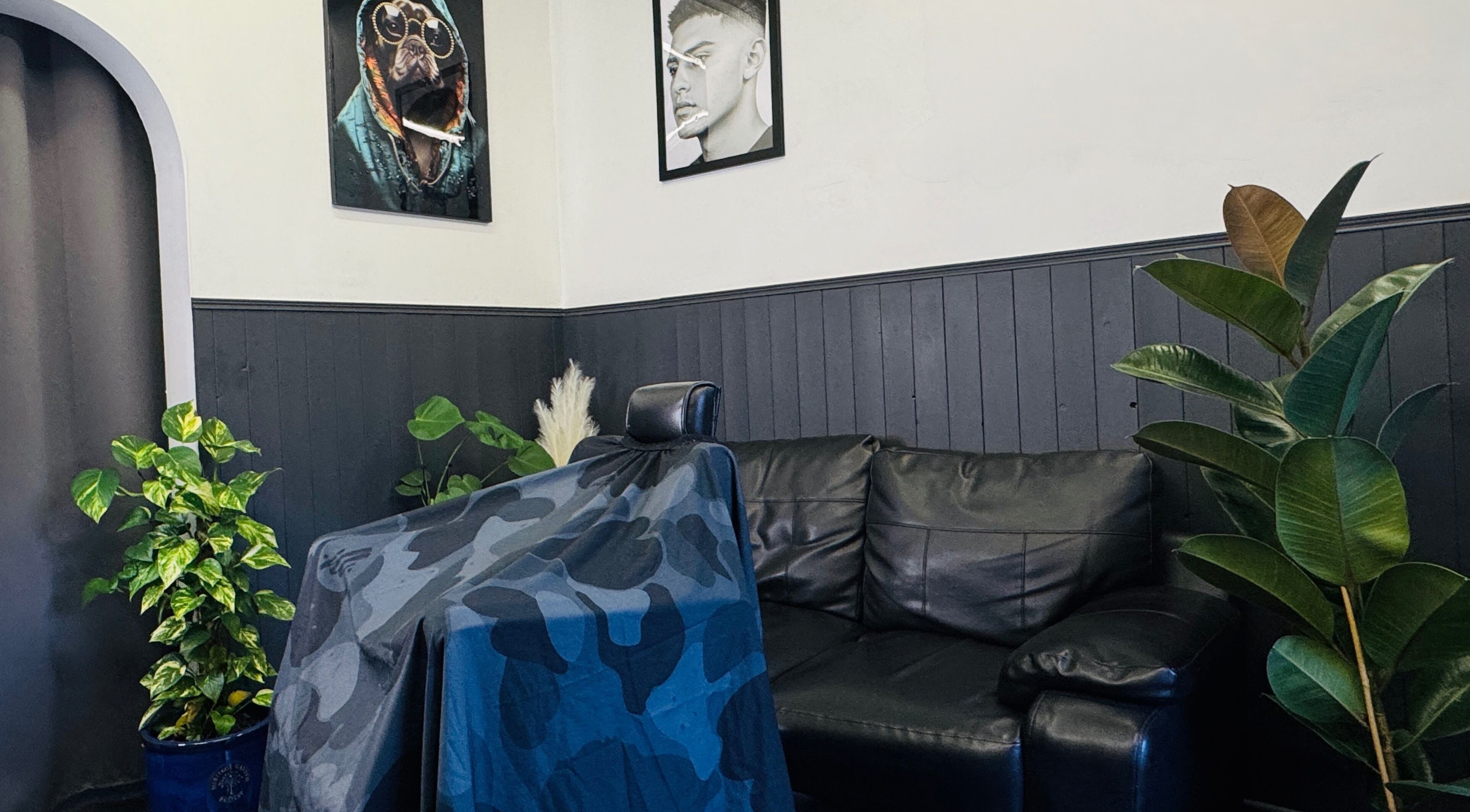 Chic interior of GavBarber in Darwen, England, GB featuring leather seating, vibrant plants, and modern decor.