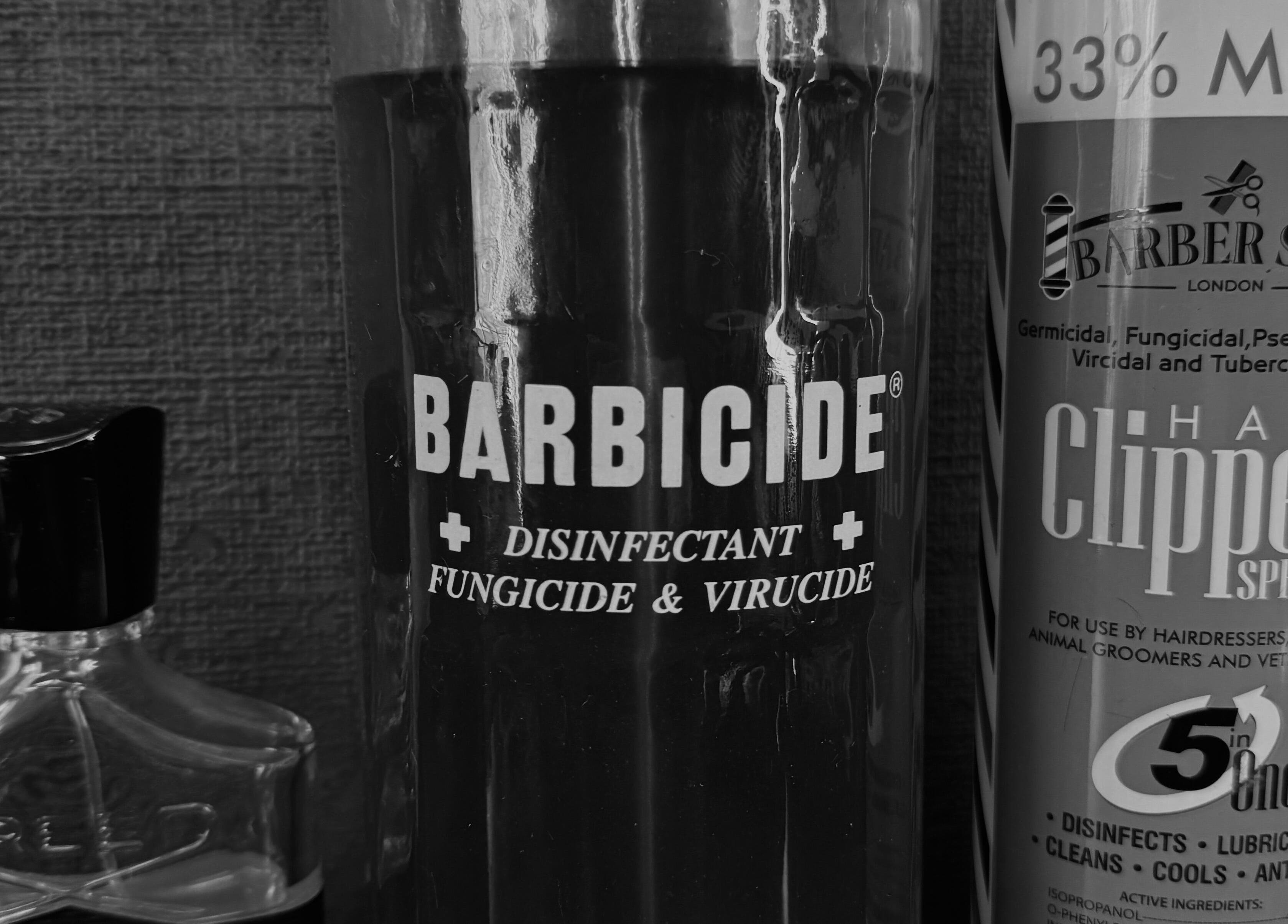 Sanitation tools at GavBarber, Darwen, England, GB ensuring hygiene with Barbicide and clipper spray.