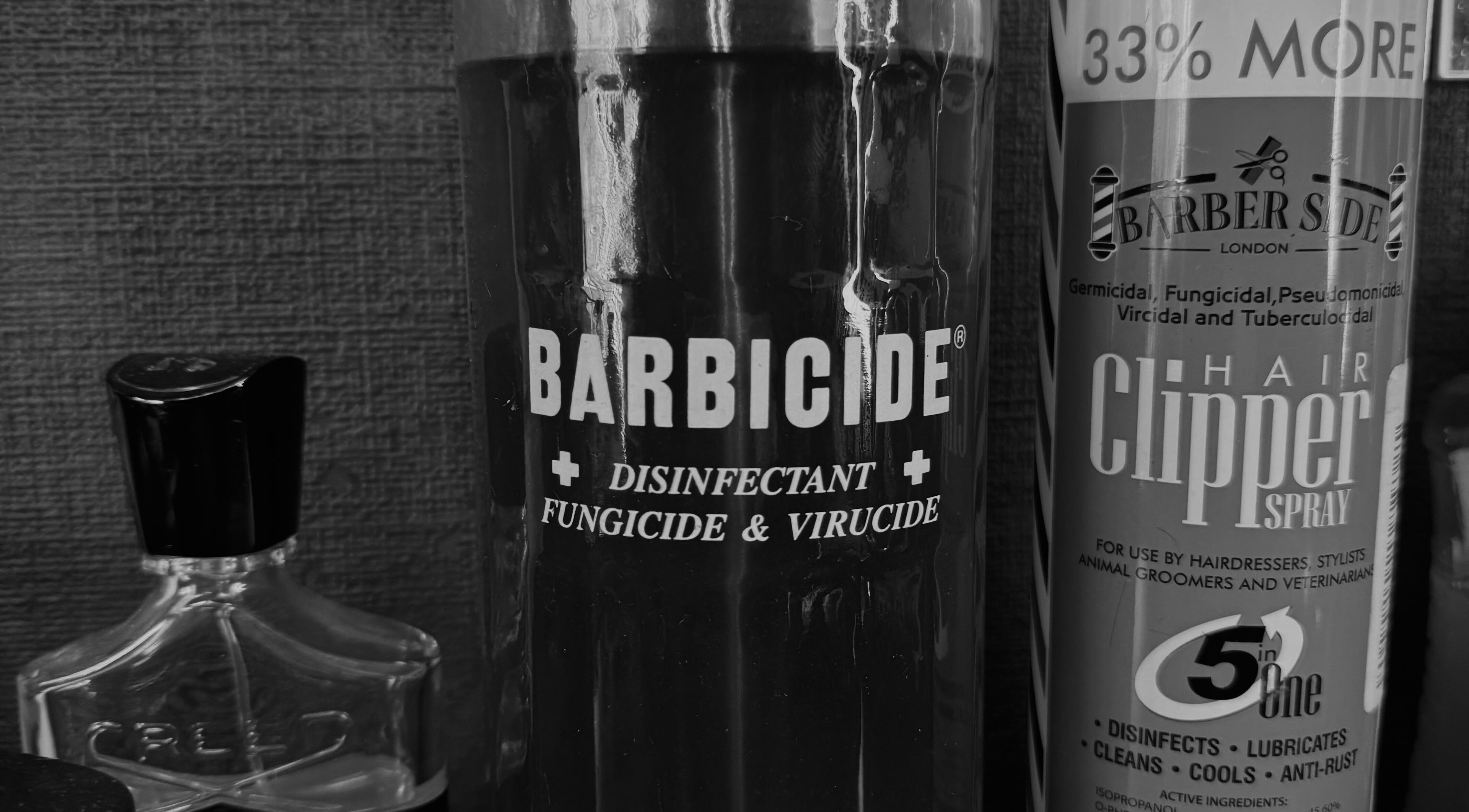 Sanitation tools at GavBarber, Darwen, England, GB ensuring hygiene with Barbicide and clipper spray.
