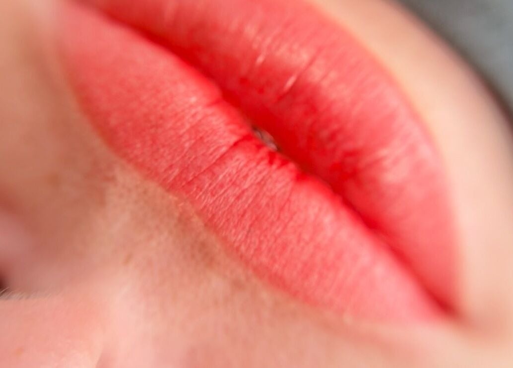 Close-up of glossy pink lips at AnglikBrowsStudio, Cundinamarca, Cundinamarca, CO, offering beauty services.