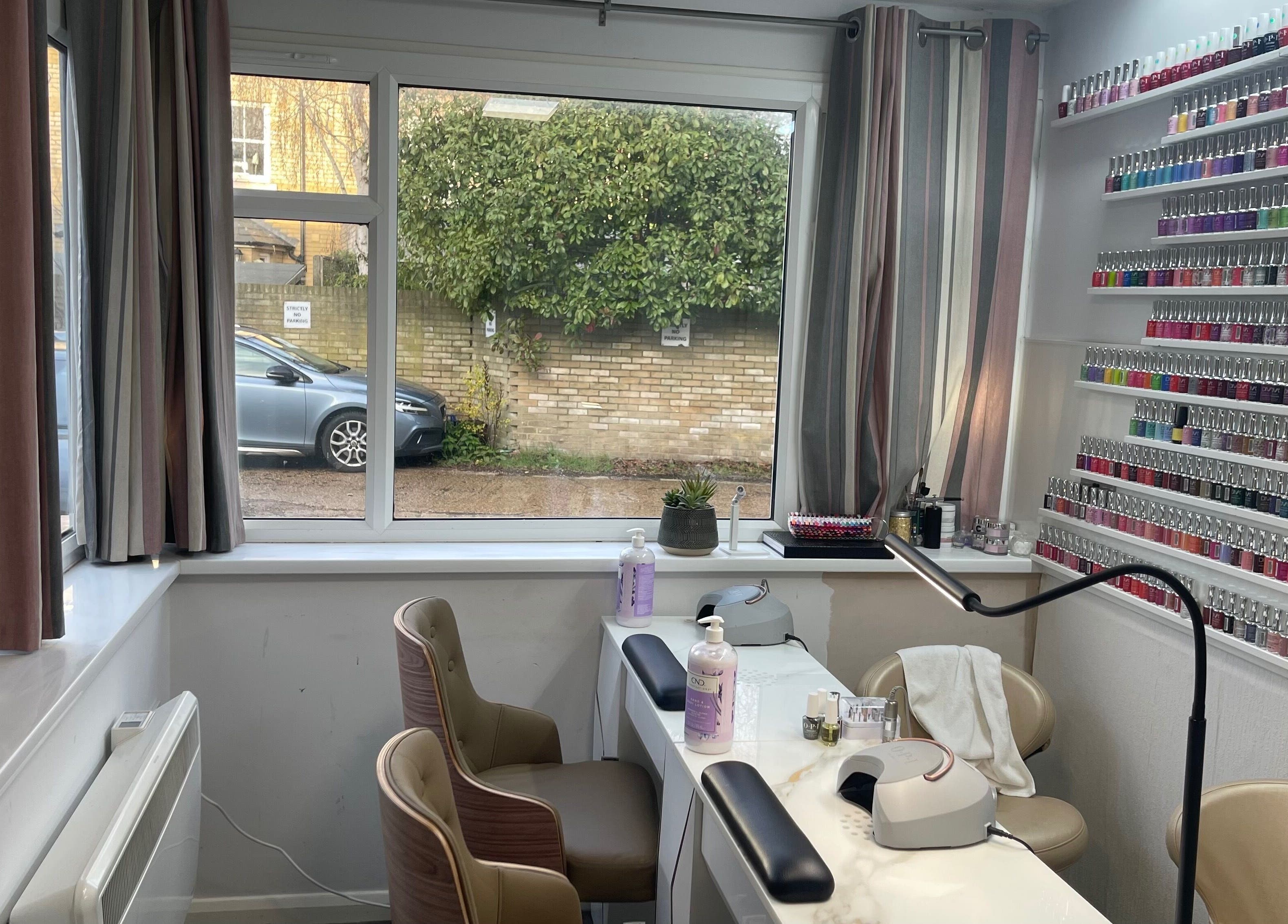 Salon K's nail area with vibrant polish display in Cambridge, England, GB.