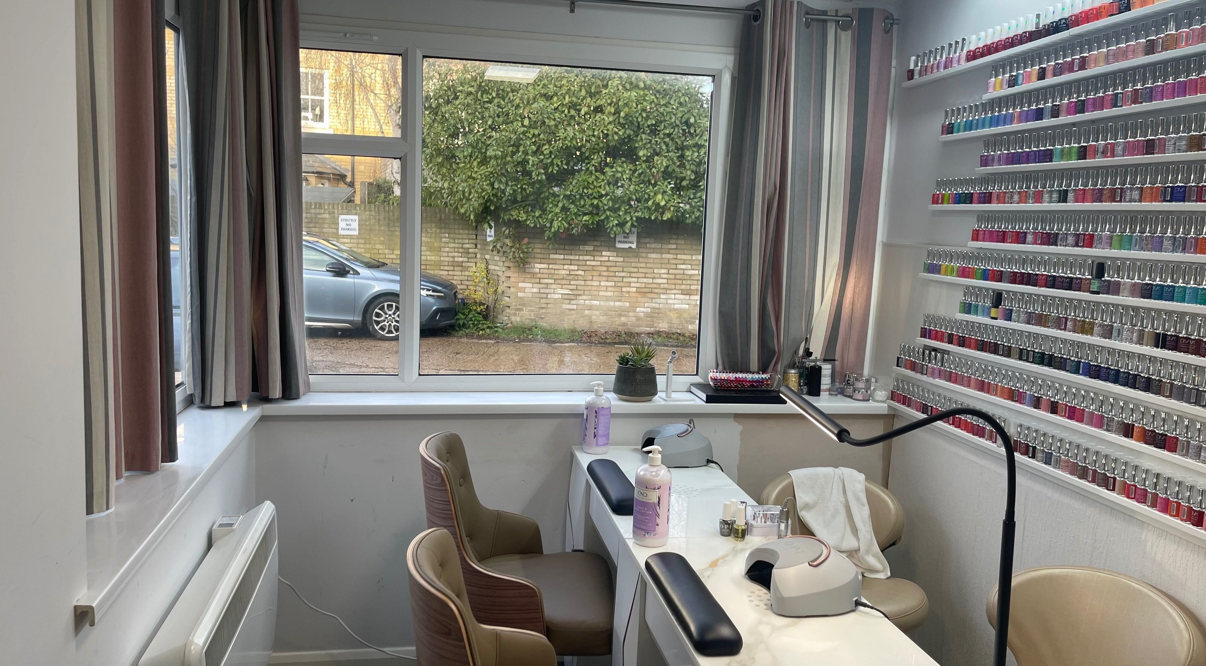 Salon K's nail area with vibrant polish display in Cambridge, England, GB.