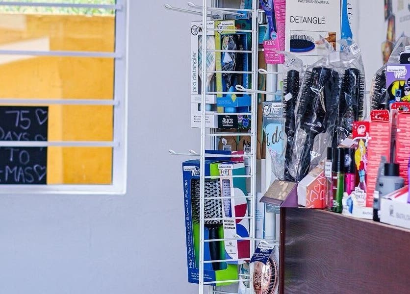 Beauty products displayed at Go Eastern Salon, Gqeberha, Eastern Cape, ZA, near a sunlit window.