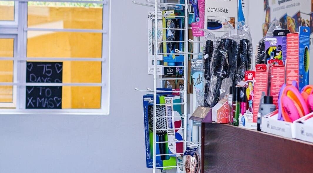 Beauty products displayed at Go Eastern Salon, Gqeberha, Eastern Cape, ZA, near a sunlit window.