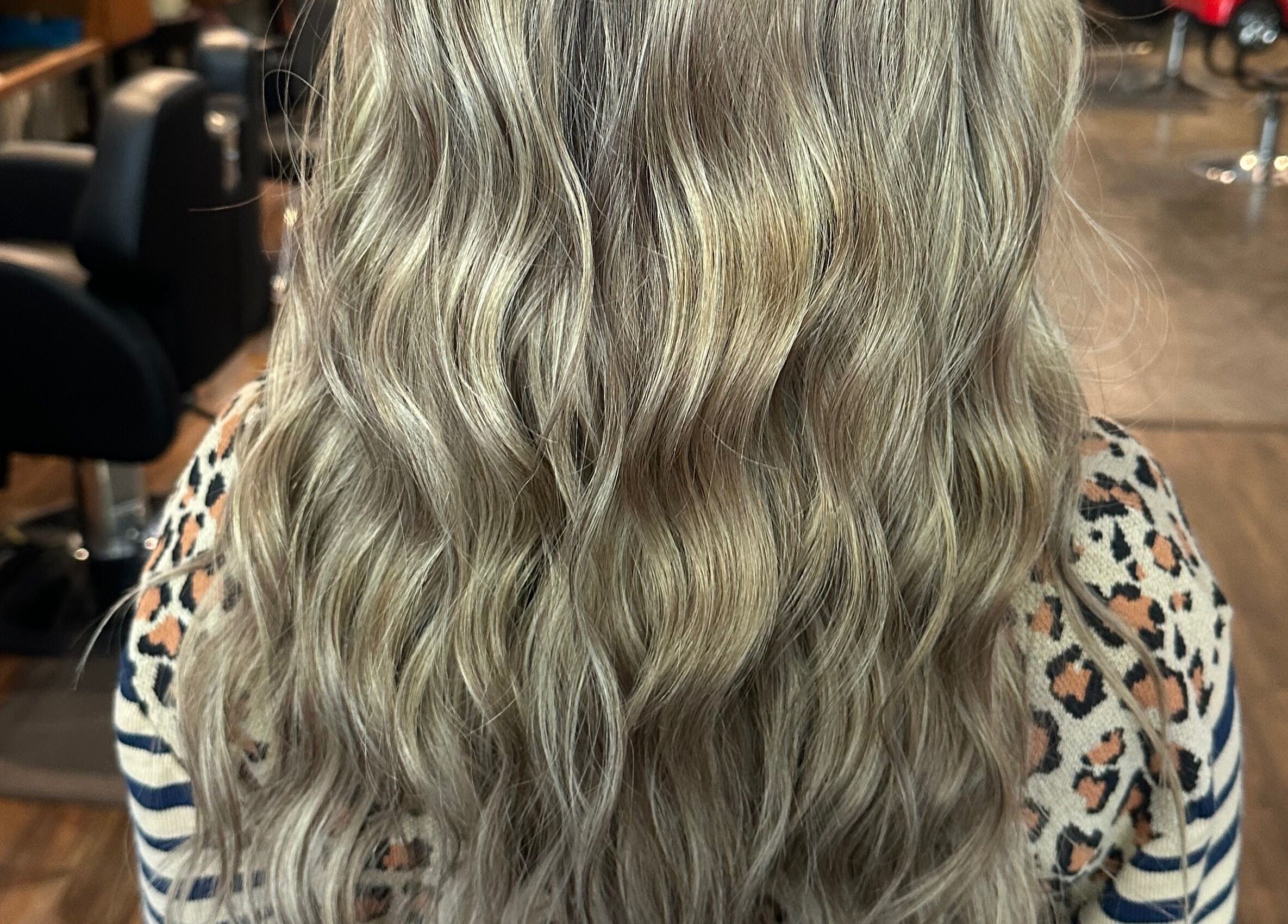 Lush wavy blonde hair styled at Tropical Rayz: Elena Garcia, Oskaloosa, Iowa, US.