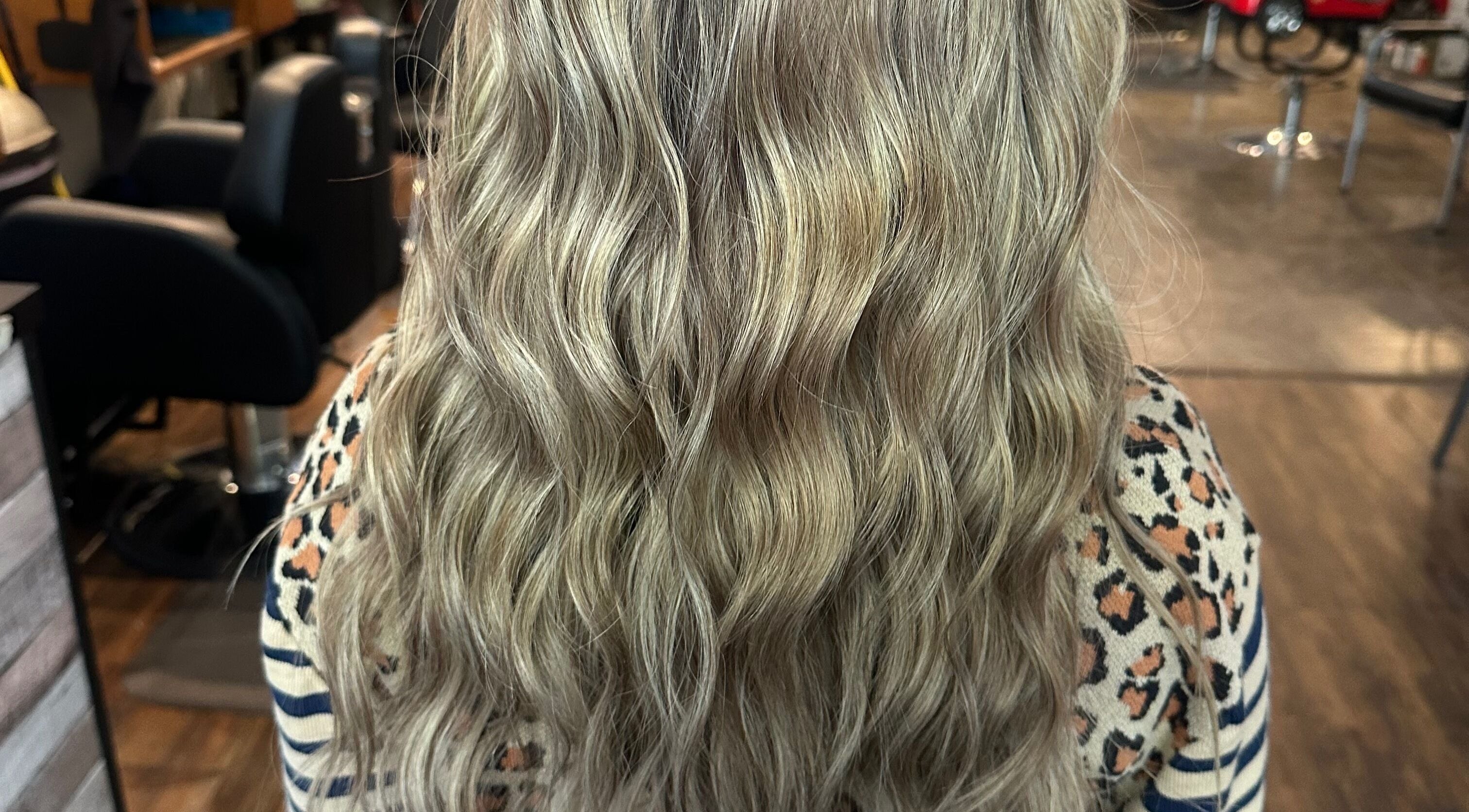 Lush wavy blonde hair styled at Tropical Rayz: Elena Garcia, Oskaloosa, Iowa, US.