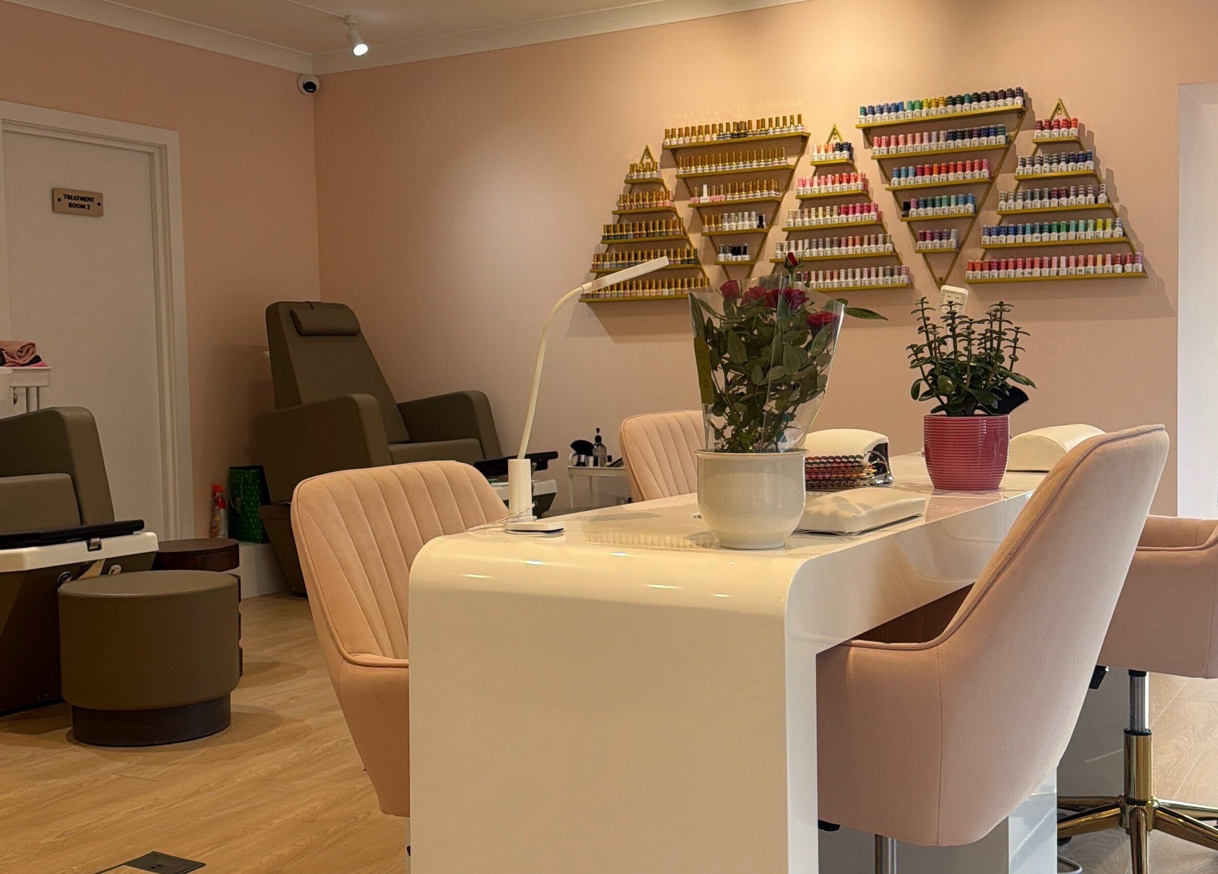 Luxurious nail area at Hampstead Medspa in London, England, GB, showcasing elegant seating and nail polish display.