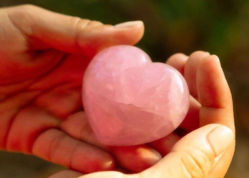 Rose quartz heart in hand at Languages of You, Bali, Bali, ID, symbolizing love and wellness.