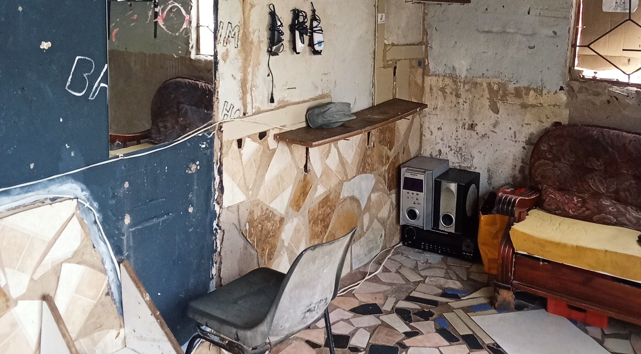 Interior view of Ka 7stata Premium Barbershop, Marble Hall, Limpopo, ZA, with vintage decor and audio equipment.