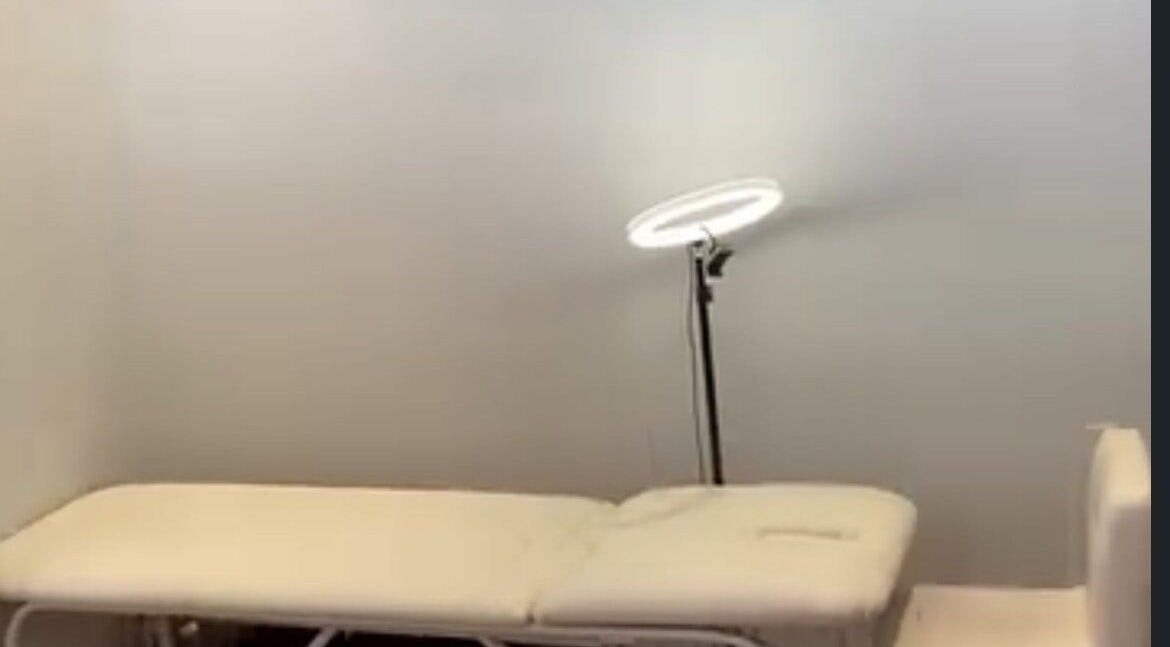 Treatment bed and ring light in Lashed by Tee, Cape Town, Western Cape, ZA, enhancing a calming spa ambiance.