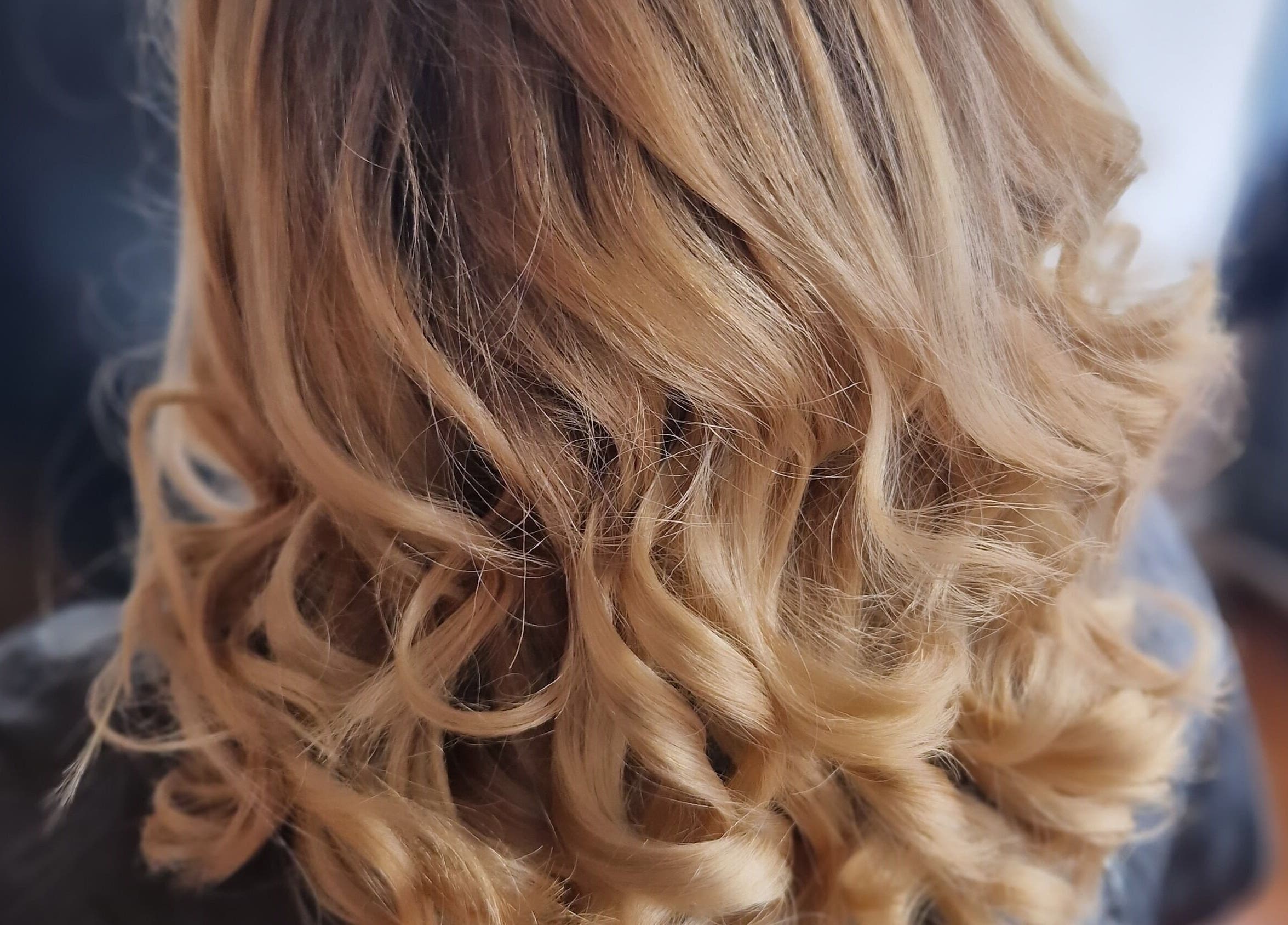 Elegant curly blonde hairstyle at KF Hair Beauty Lifestyle, Fleetwood, England, GB.