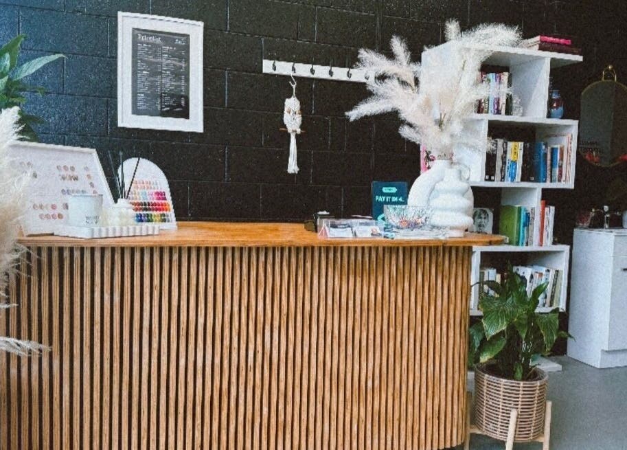 Reception area of StudioBeauty nails spa salon in Porirua, Wellington Region, NZ with stylish decor and greenery.