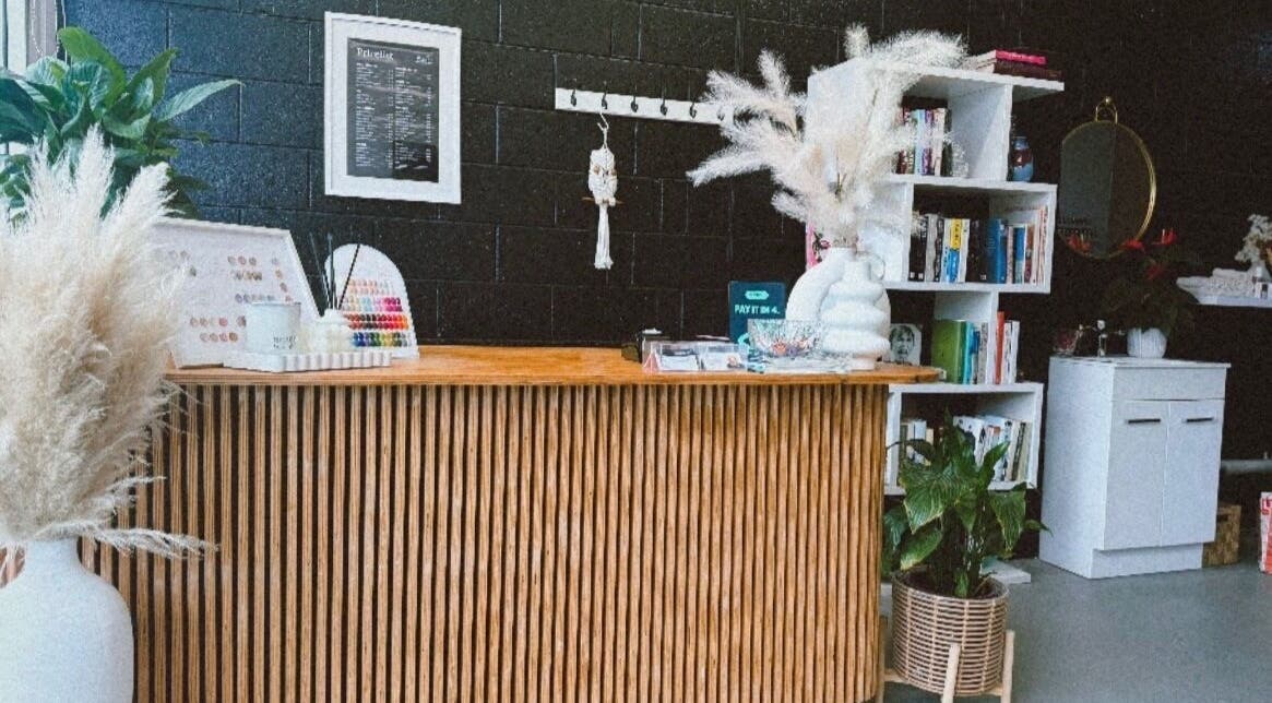 Reception area of StudioBeauty nails spa salon in Porirua, Wellington Region, NZ with stylish decor and greenery.