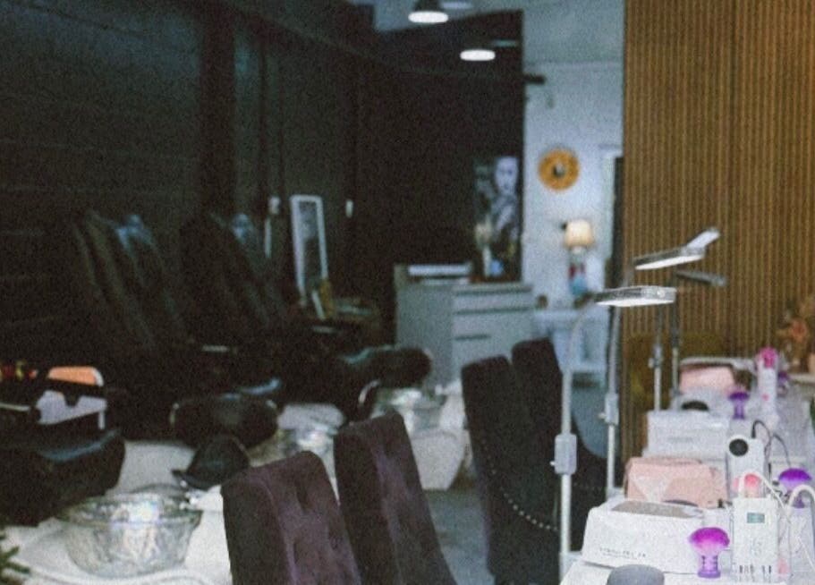 Luxurious interior of StudioBeauty nails spa salon in Porirua, Wellington Region, NZ with plush seating and nail stations.