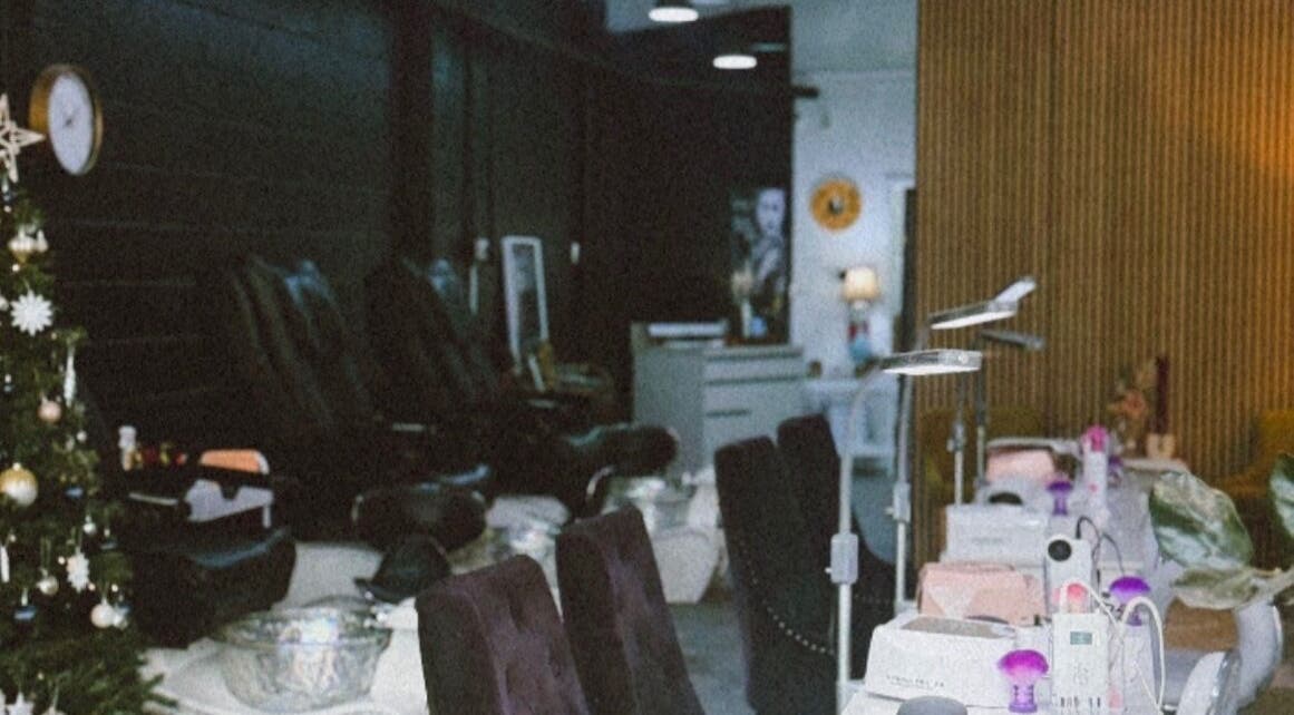 Luxurious interior of StudioBeauty nails spa salon in Porirua, Wellington Region, NZ with plush seating and nail stations.