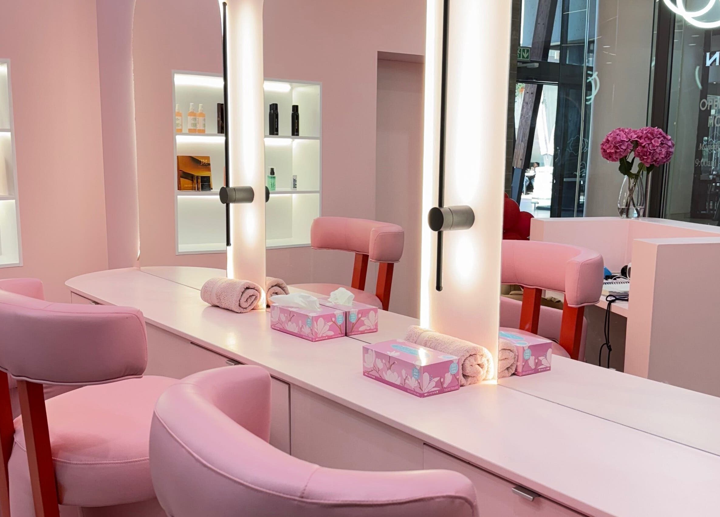 Chic pink salon interior at Lethal Beauty in Midrand, Gauteng, ZA, showcasing modern styling stations.
