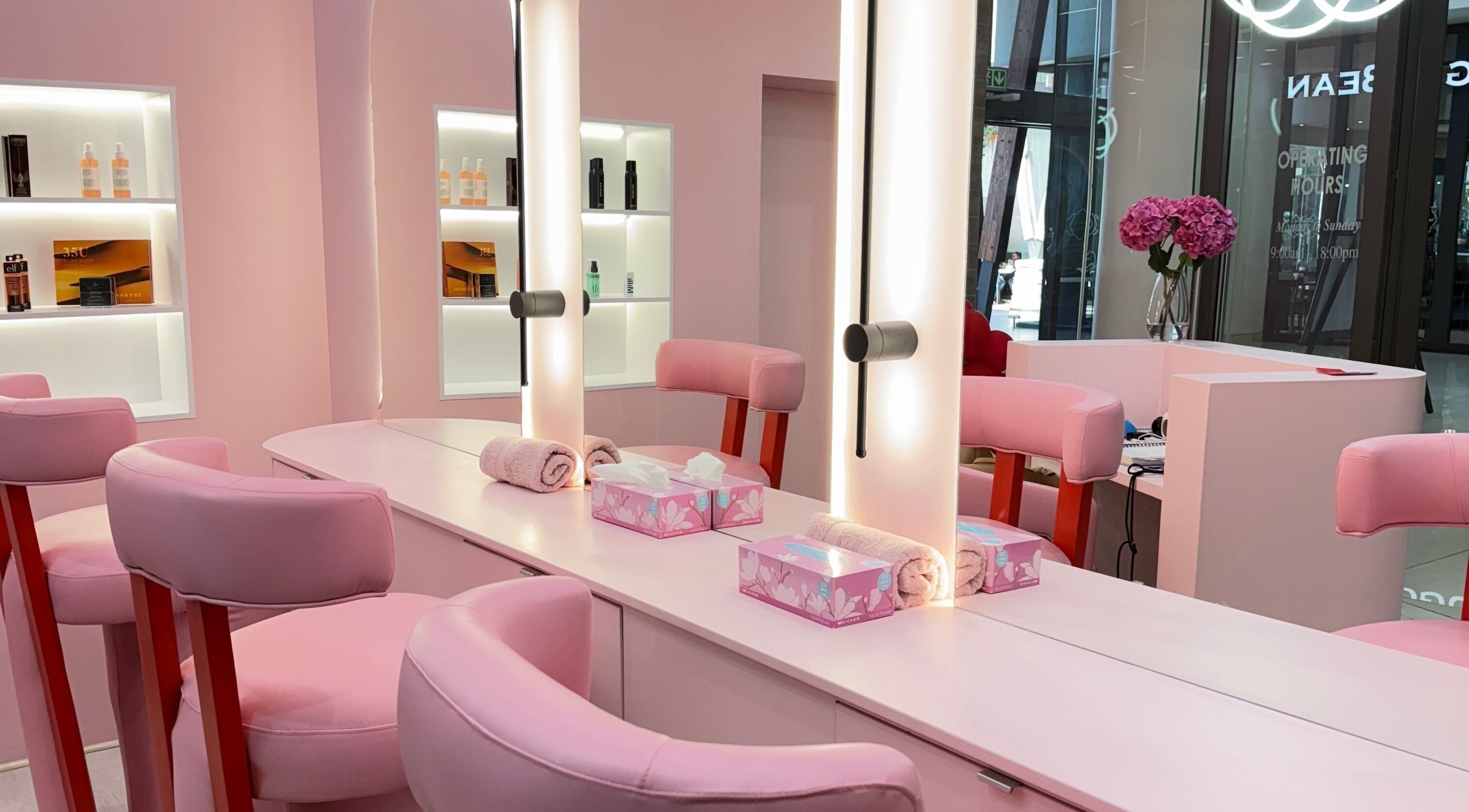 Chic pink salon interior at Lethal Beauty in Midrand, Gauteng, ZA, showcasing modern styling stations.