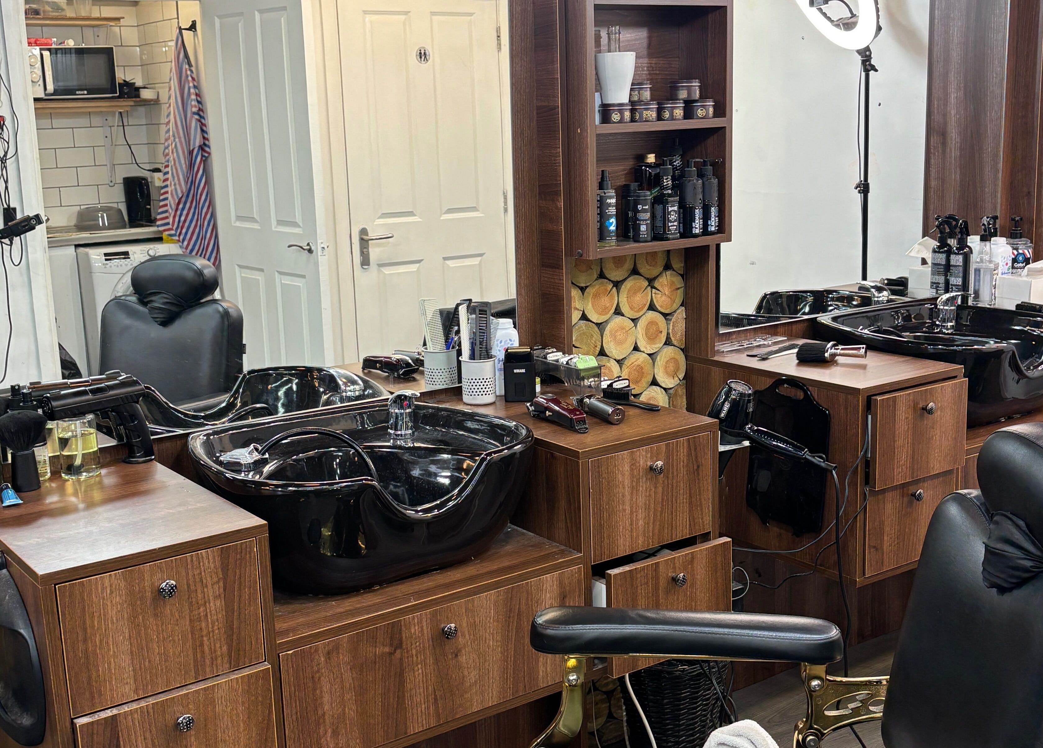 Modern barber station at M&k Barbers, Brighton And Hove, England, GB with sleek tools and styling chairs.