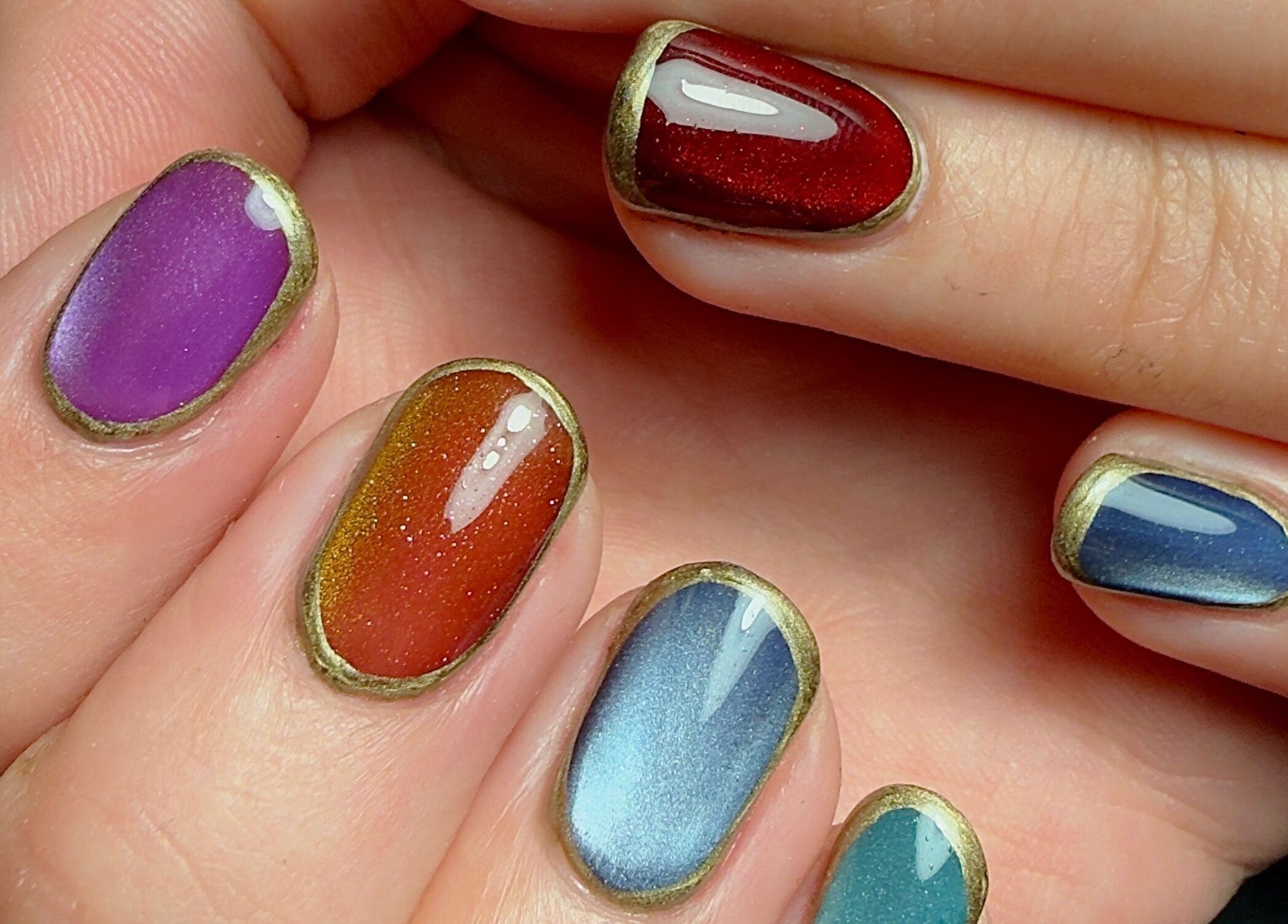 Colorful nail art in vibrant shades at Laurs Claws, Bedford, England, GB. Showcasing expert nail design.