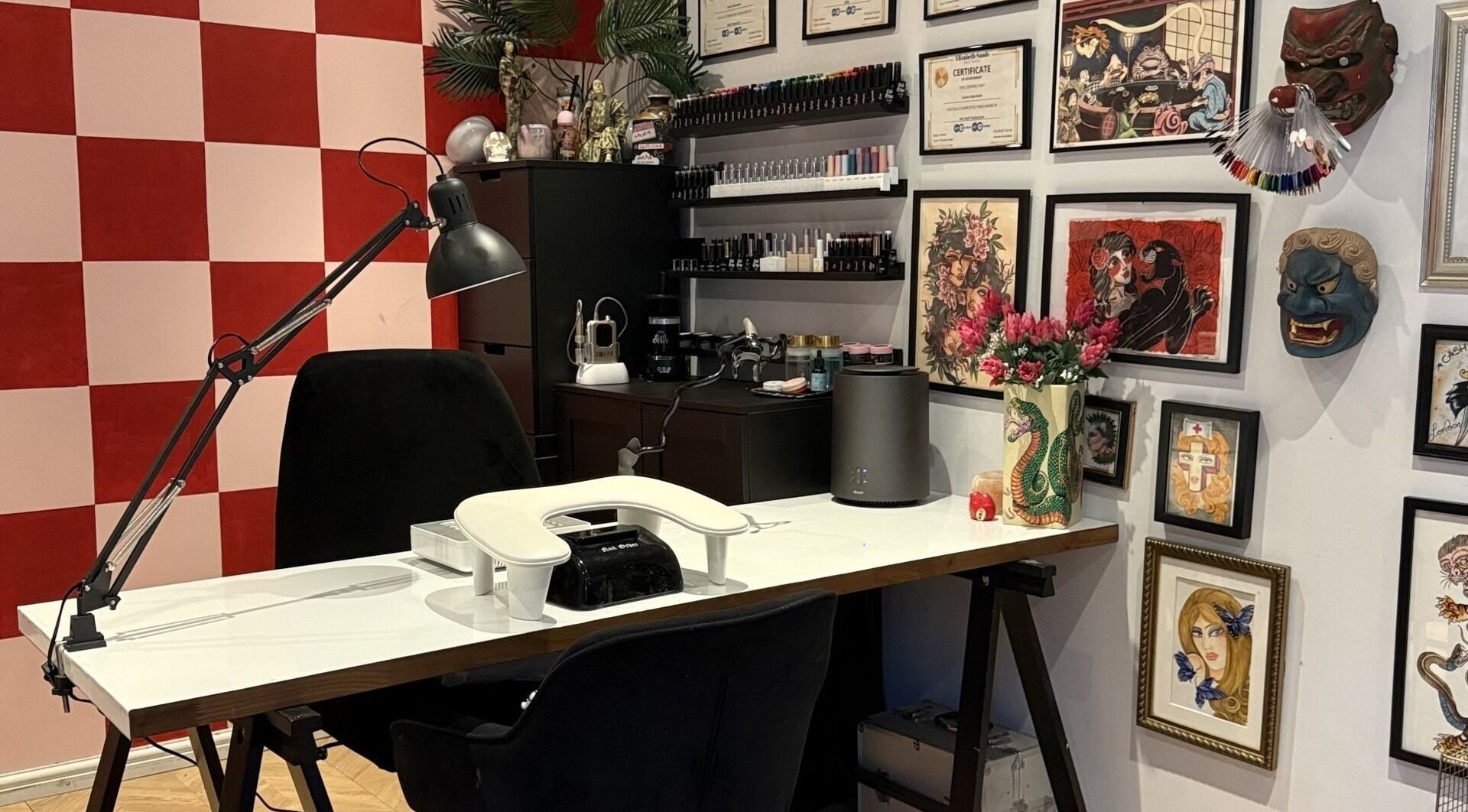 Cozy nail station at Laurs Claws in Bedford, England, GB. Adorned with art and certificates for a creative vibe.