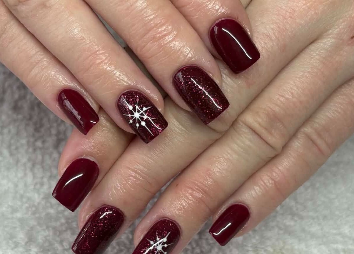 Elegant red nails design at Carli Esthetics in Cornwall, Ontario, CA showcasing flawless artistic details.