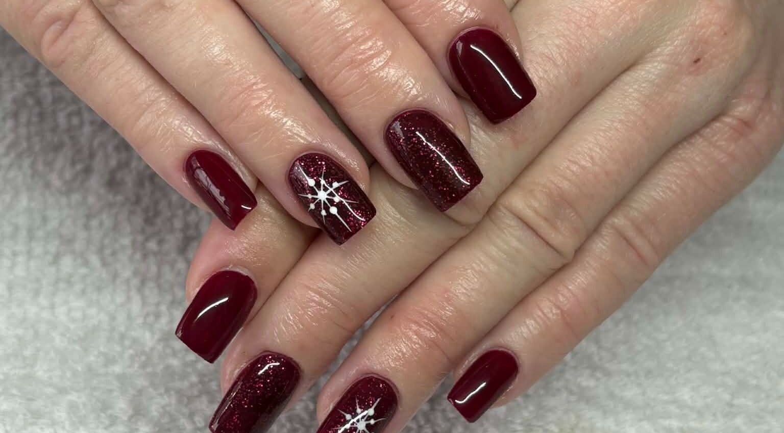 Elegant red nails design at Carli Esthetics in Cornwall, Ontario, CA showcasing flawless artistic details.