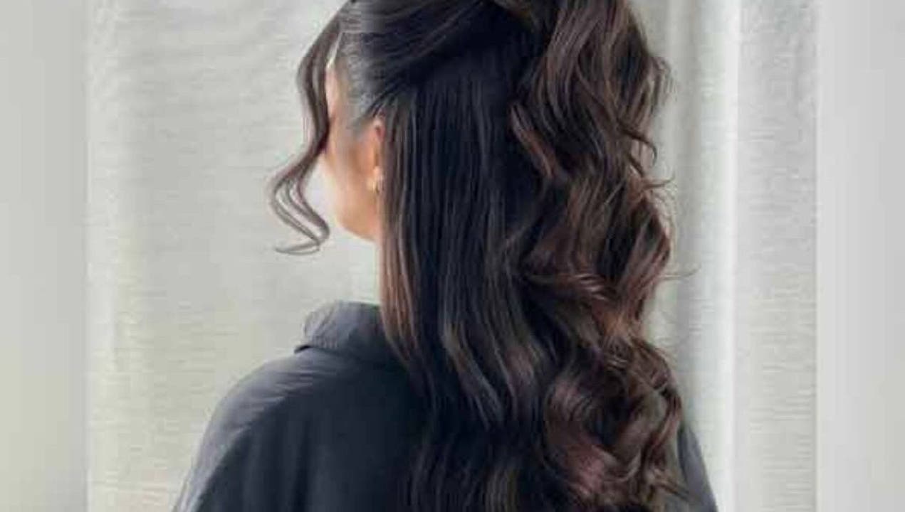 Elegant wavy hairstyle featured at Test venue, IR, showcasing healthy, glossy, dark hair.