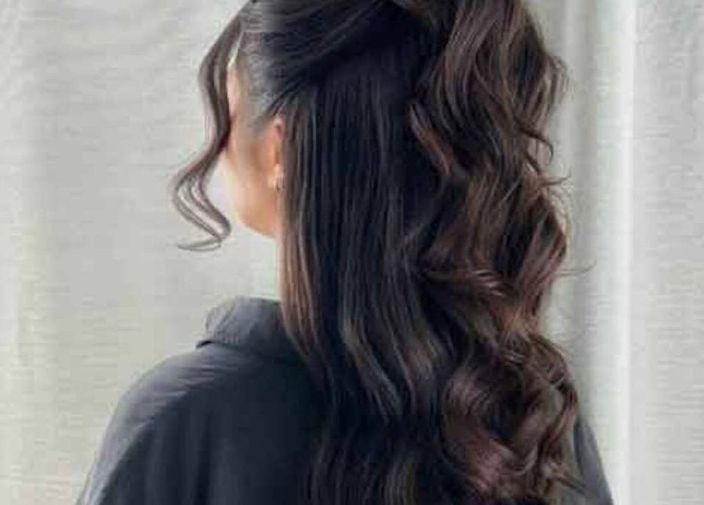 Elegant wavy hairstyle featured at Test venue, IR, showcasing healthy, glossy, dark hair.