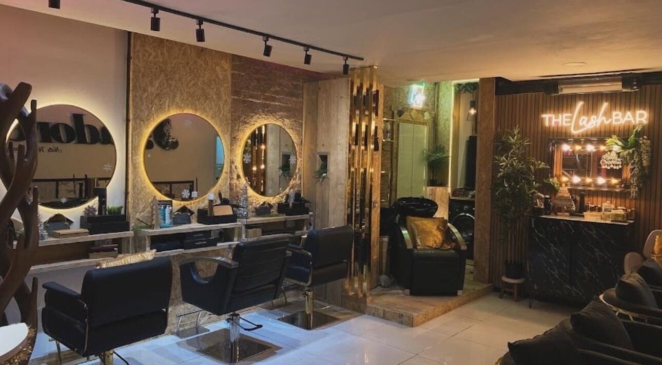 Chic interior of Beauty By Payton salon in Sunderland, England, GB, showcasing elegant styling stations and lush decor.