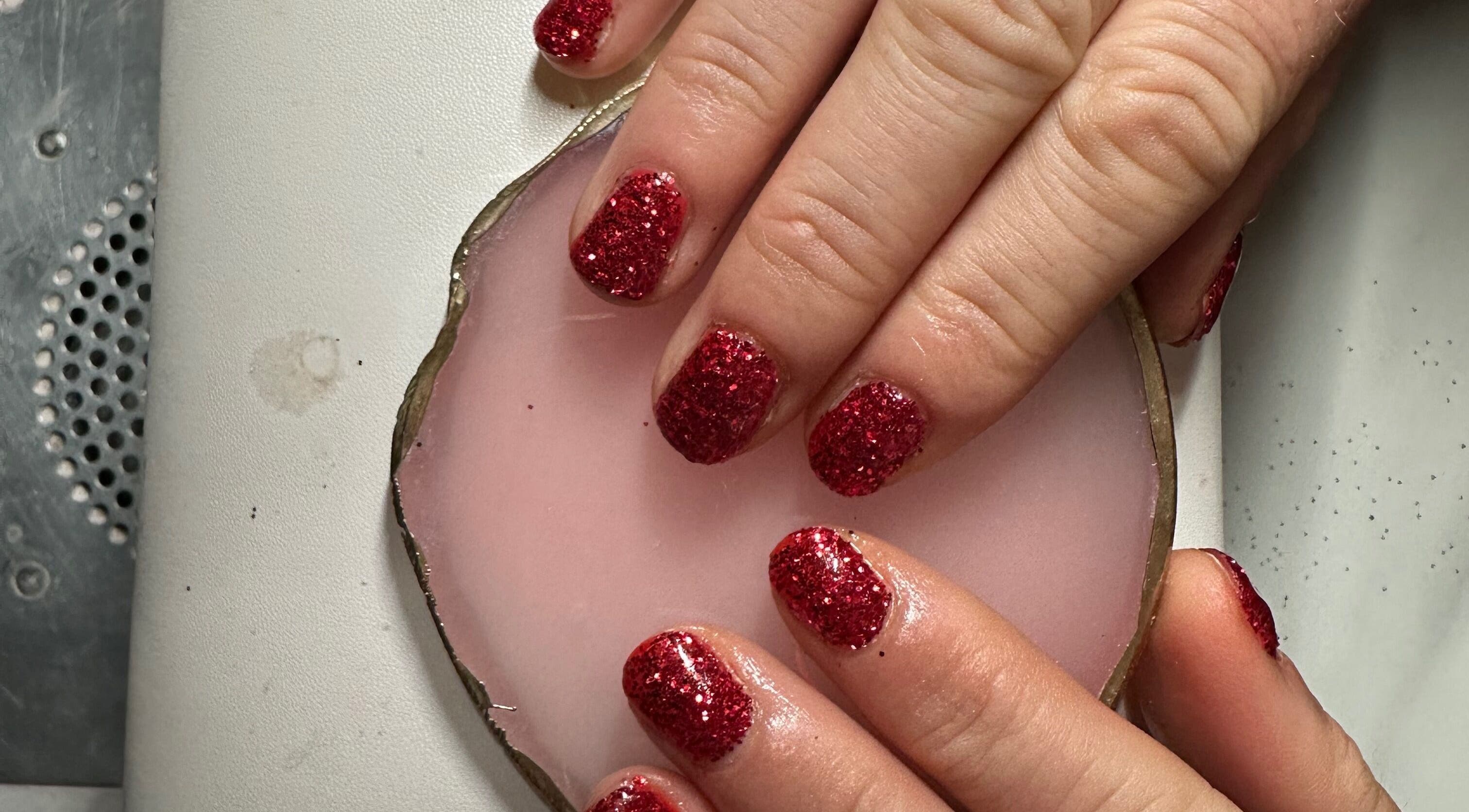Red glitter nails on a soft pink pad at Beauty By Payton, Sunderland, England, GB.