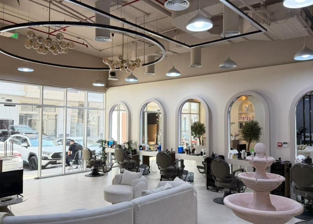 Stylish interior of Three Brothers Barbershop in Sharjah, AE with modern decor and large mirrors.