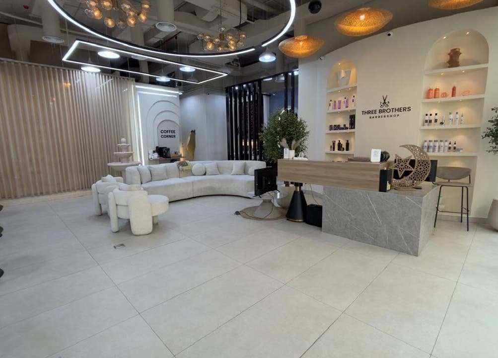 Modern interior of Three Brothers Barbershop, Sharjah, AE with elegant seating and product displays.