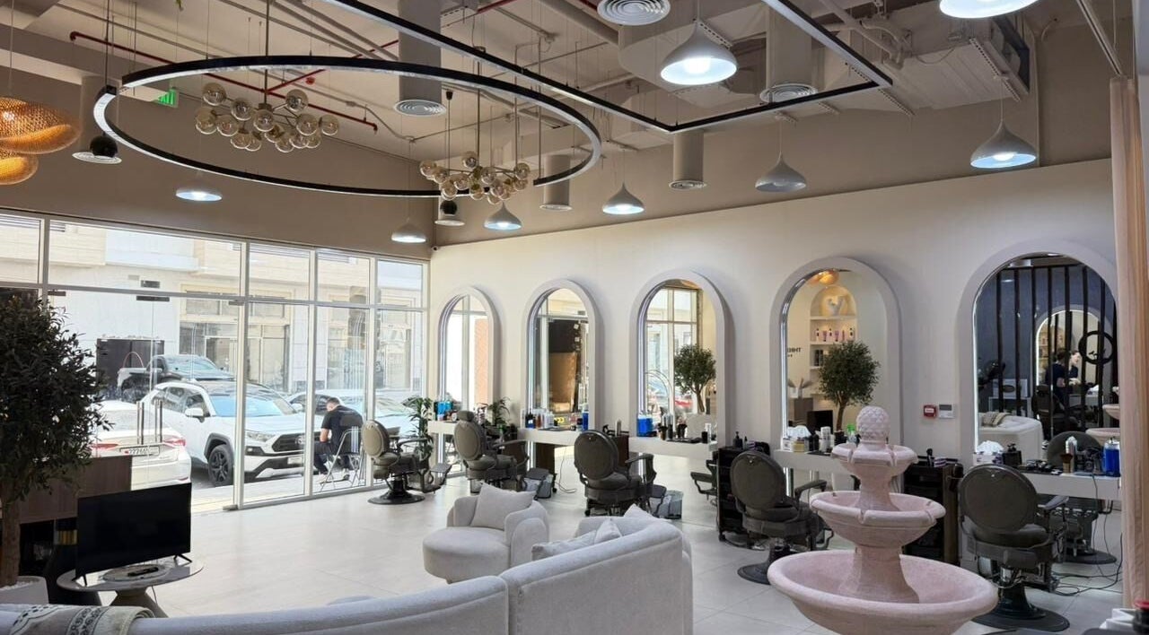 Spacious interior of Three Brothers Barbershop in Sharjah, AE, showcasing modern decor and stylish seating.