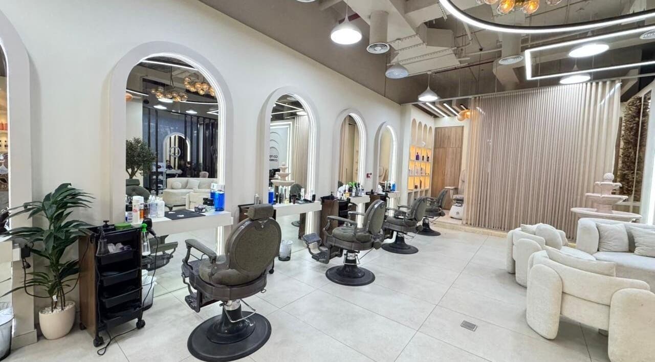 Spacious interior of Three Brothers Barbershop in Sharjah, AE, featuring chic barber chairs and stylish decor.