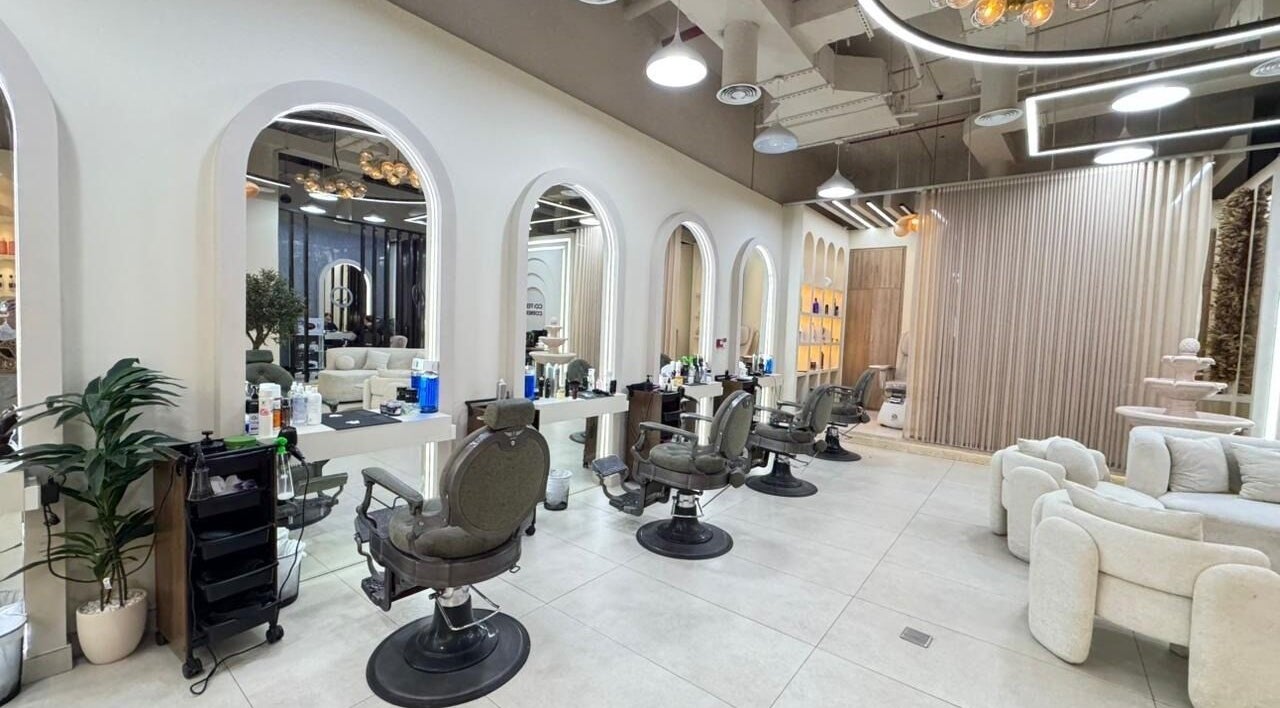 Spacious interior of Three Brothers Barbershop in Sharjah, AE, featuring chic barber chairs and stylish decor.