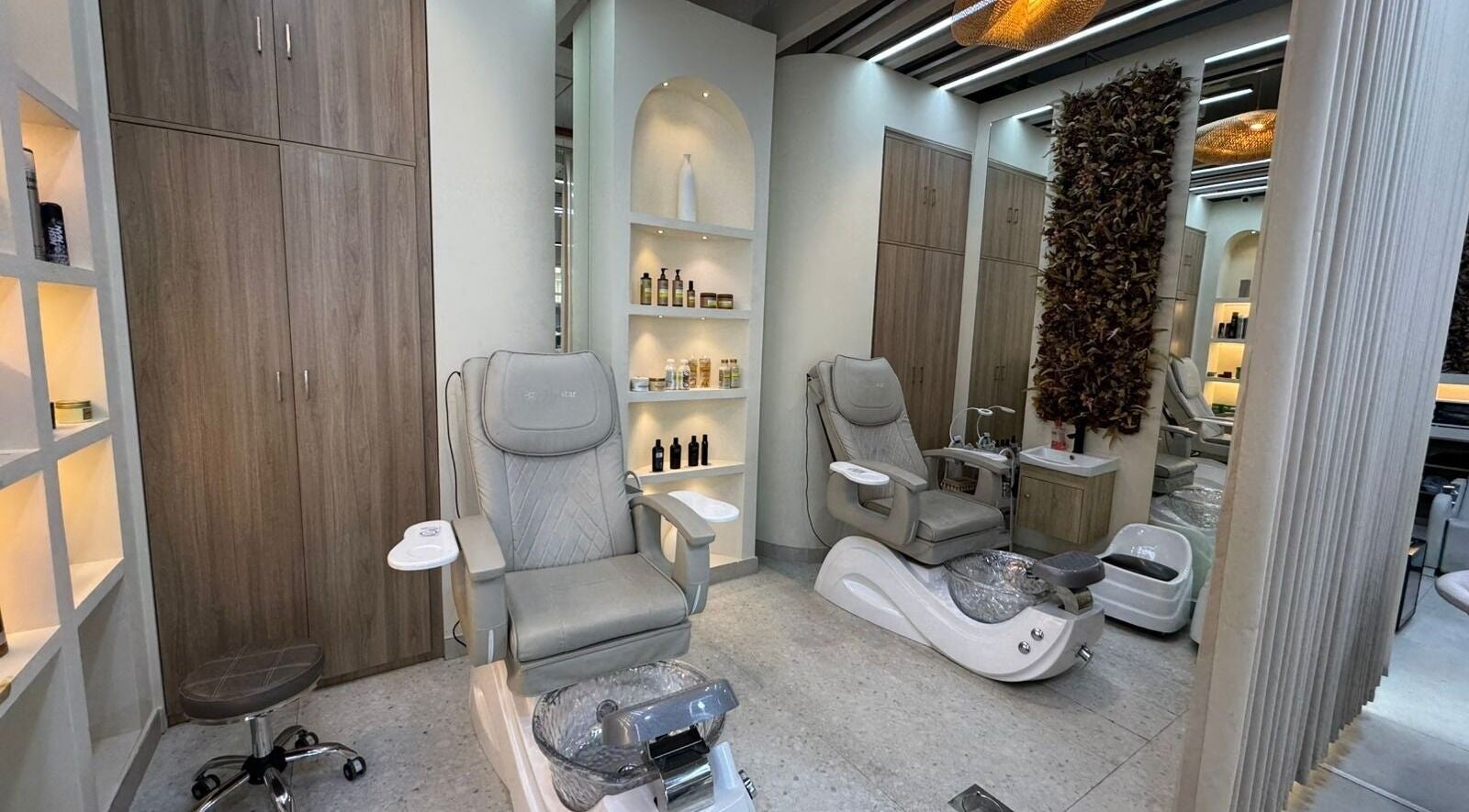 Elegant interior of Three Brothers Barbershop in Sharjah, AE with luxurious pedicure chairs and stylish decor.