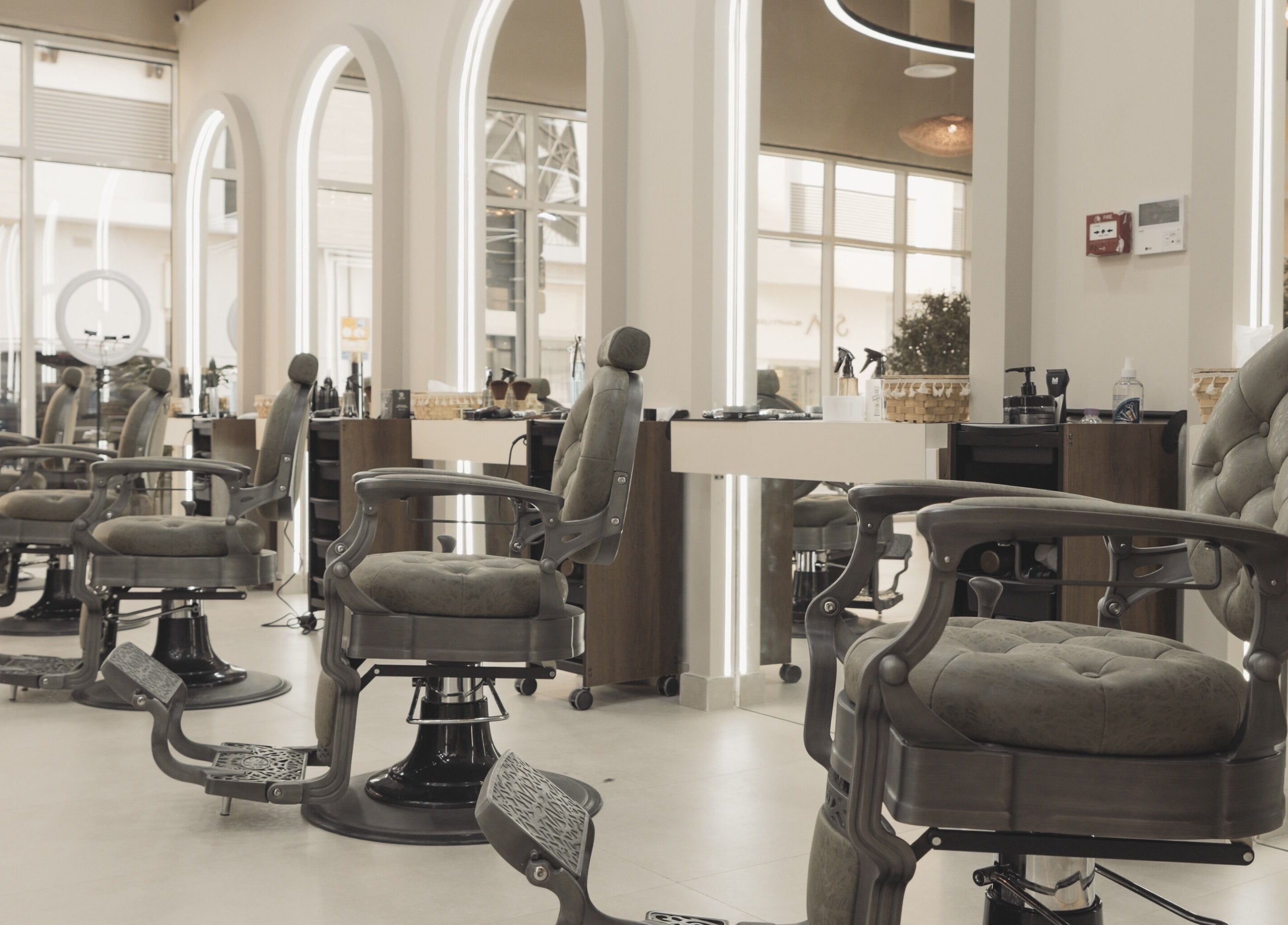 Modern interior of Three Brothers Barbershop, Sharjah, AE with stylish barber chairs and mirrors.