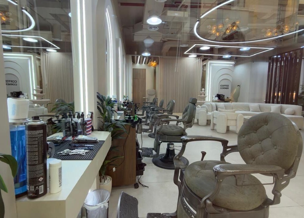Elegant interior of Three Brothers Barbershop in Sharjah, AE, featuring modern chairs and mirrors.