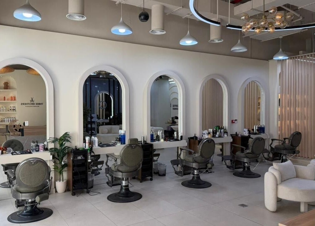 Chic interior of Three Brothers Barbershop in Sharjah, AE featuring stylish barber chairs and modern decor.