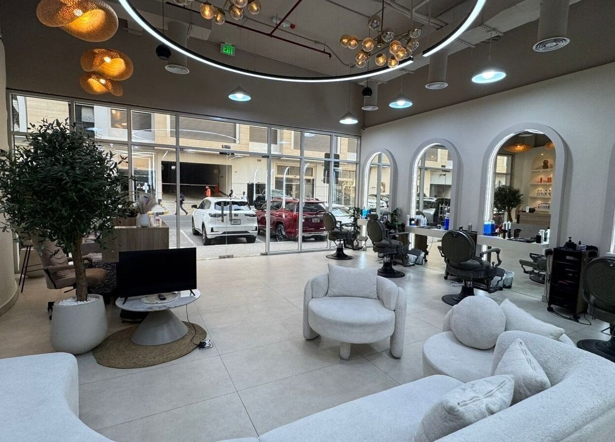 Interior of Three Brothers Barbershop in Sharjah, AE showcasing modern seating and styling stations.