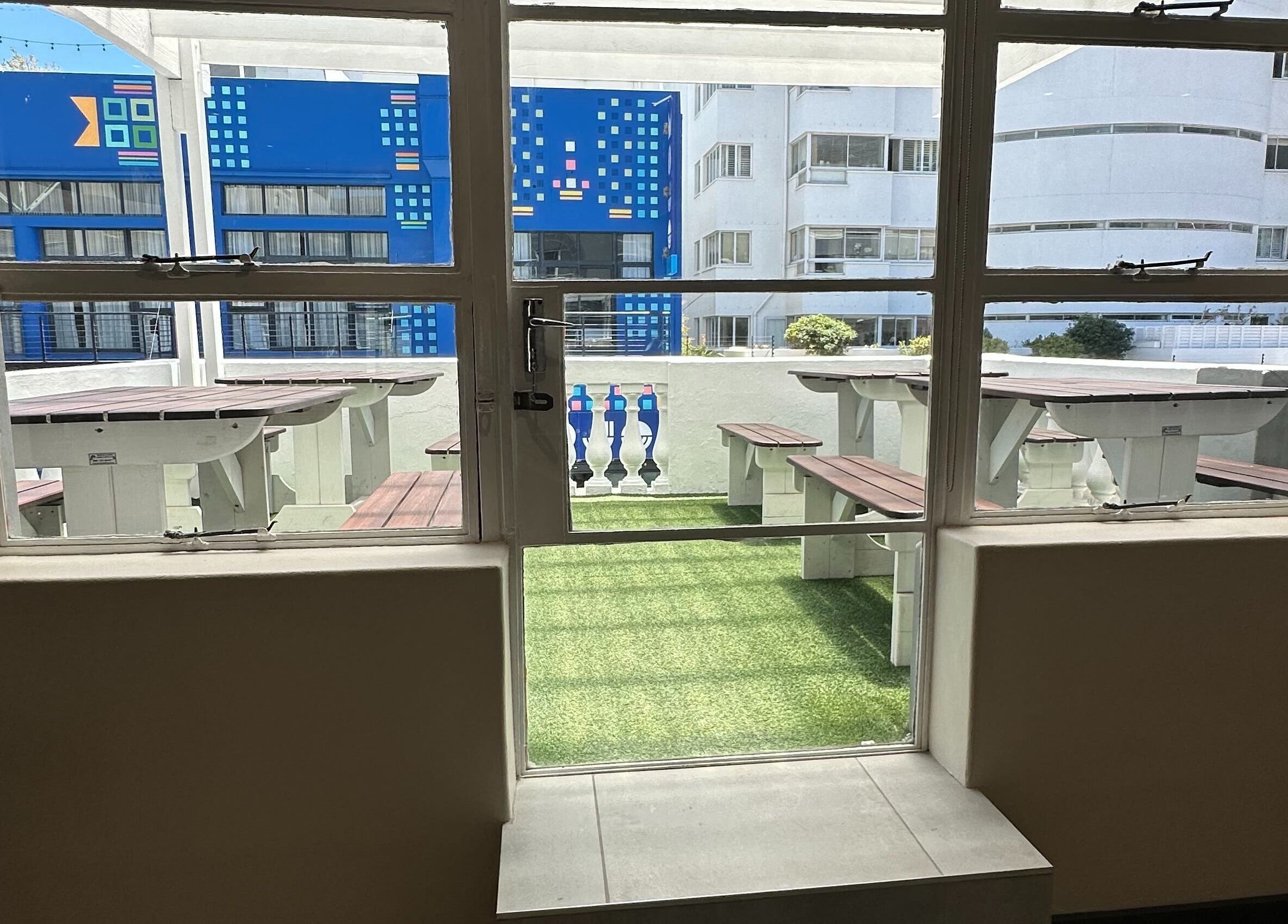 View of outdoor seating at Wax On Wax Off, Sea Point, Western Cape, ZA, showcasing modern design.