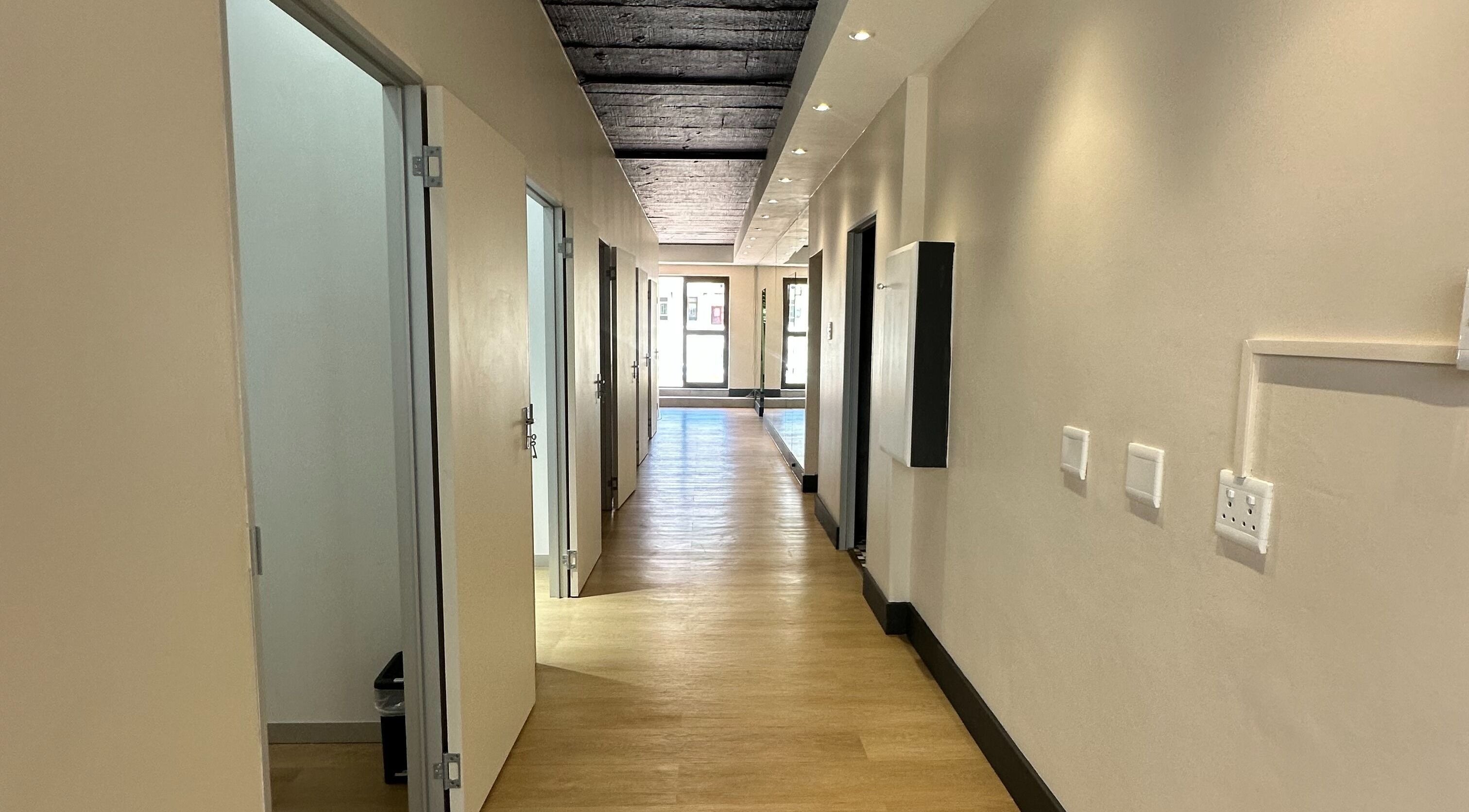 Elegant hallway at Wax On Wax Off, Cape Town, Western Cape, ZA with open doors inviting relaxation and wellness.