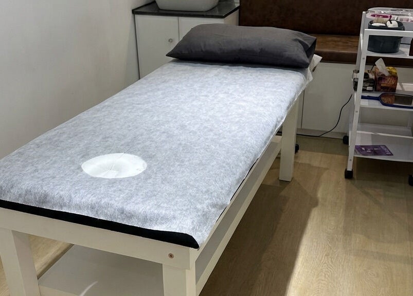 Relaxing spa treatment room at Wax On Wax Off in Cape Town, Western Cape, ZA with a comfortable treatment table.