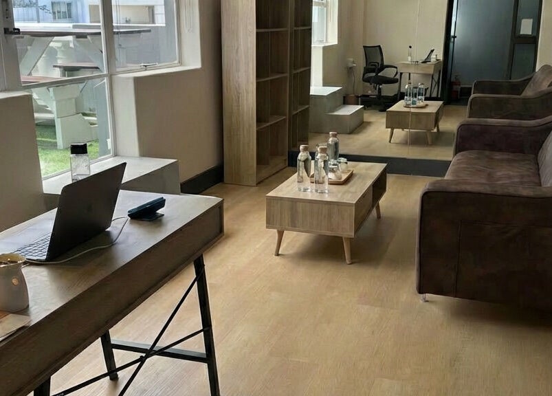 Inviting waiting area at Wax On Wax Off, Cape Town, Western Cape, ZA, with cozy seating and work desk.