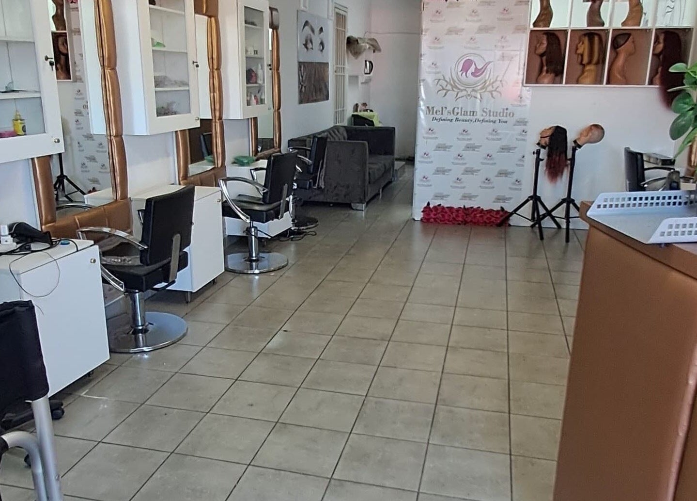 Inside Mel’sGlam Studio, Johannesburg, Gauteng, ZA: modern seating, styling stations, and vibrant decor.